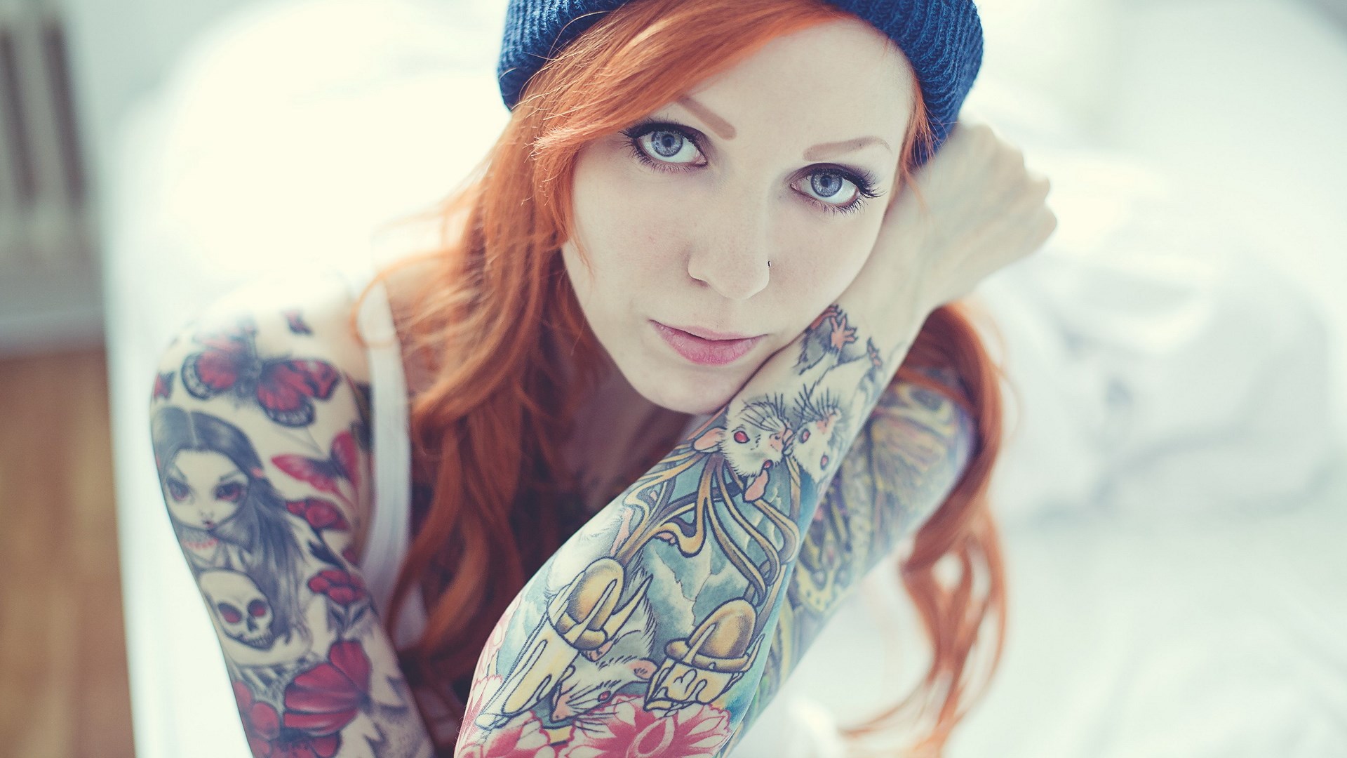 Woman with red hair and tattoos wearing a blue beanie HD Wallpaper