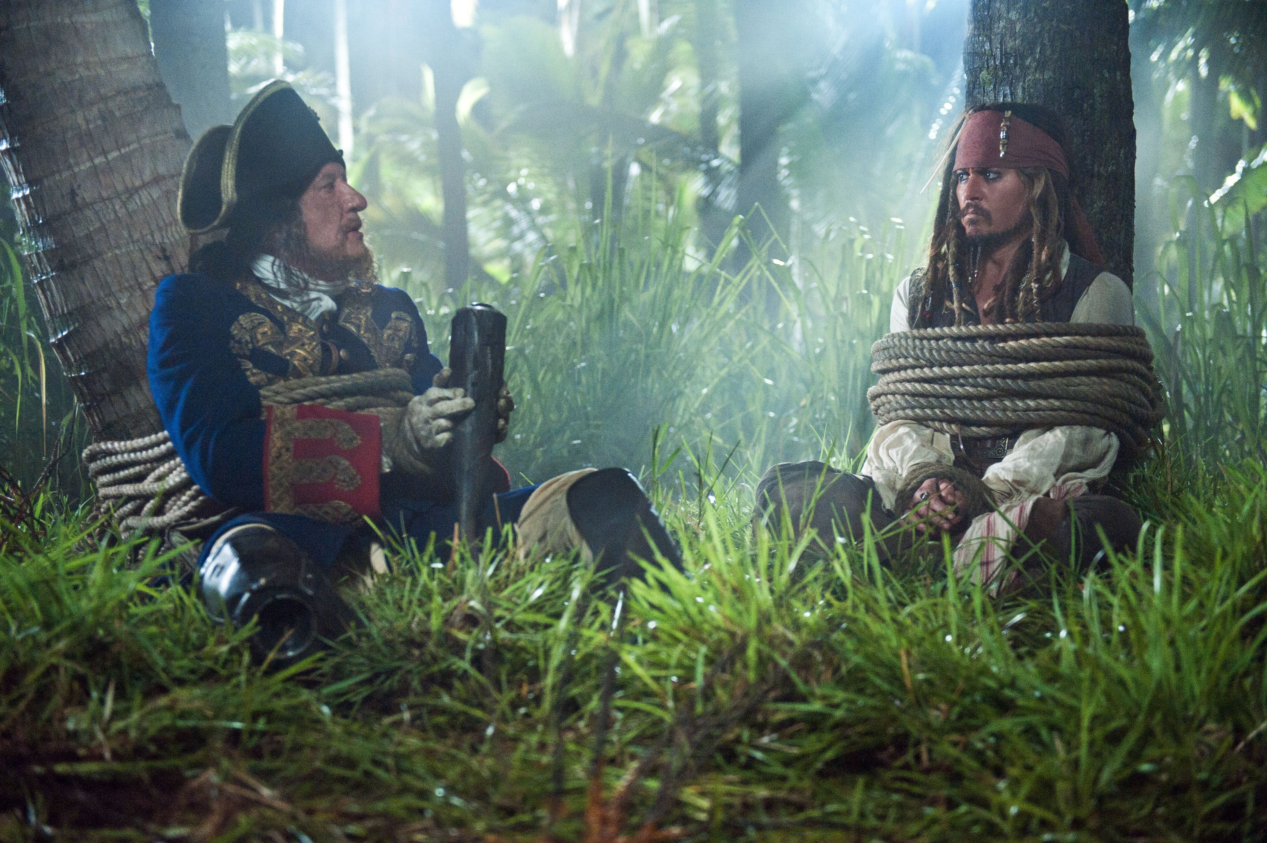 Geoffrey Rush and Johnny Depp tied up in a jungle HD Wallpaper