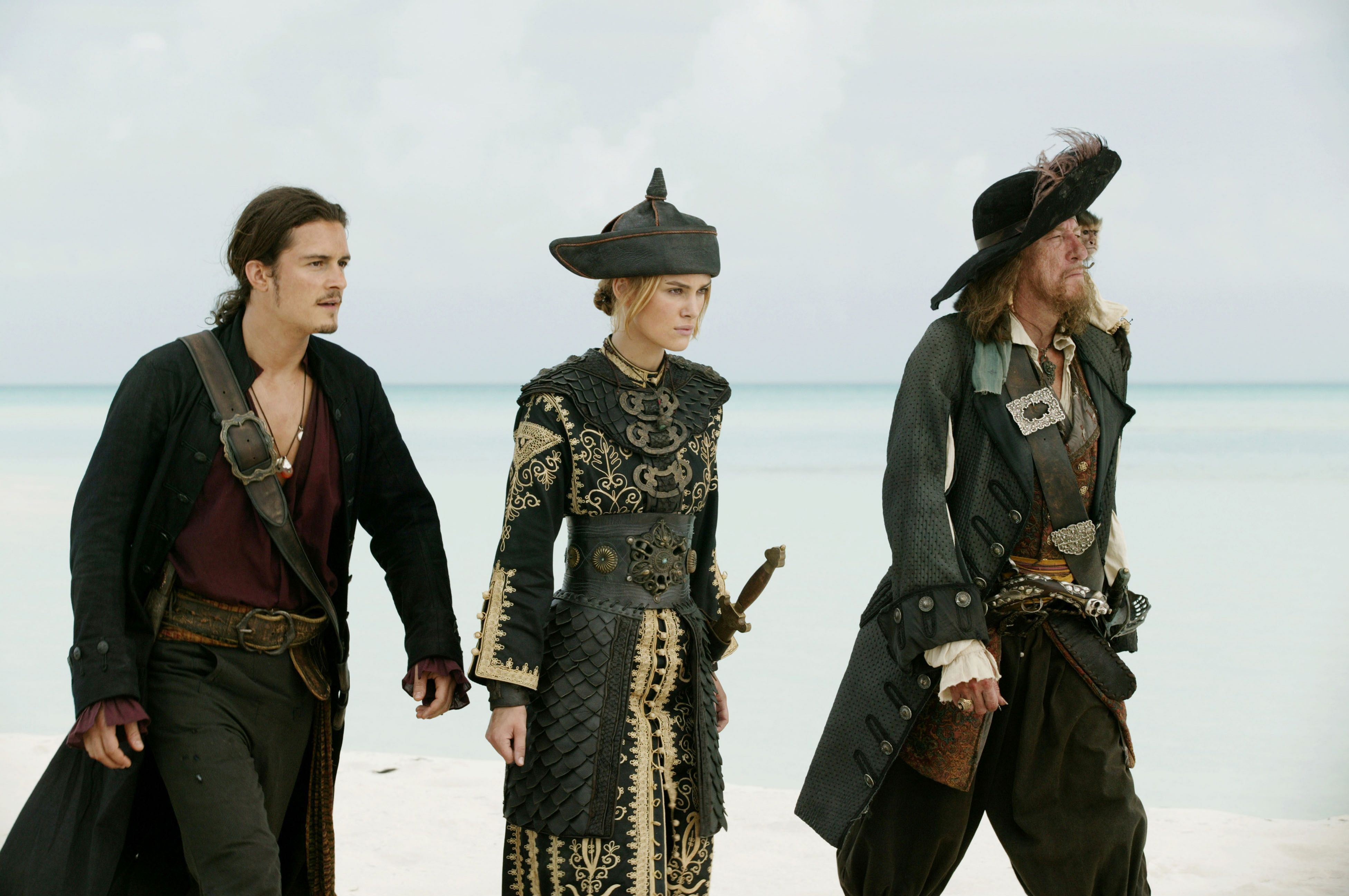 Geoffrey Rush and two other pirates on a beach HD Wallpaper