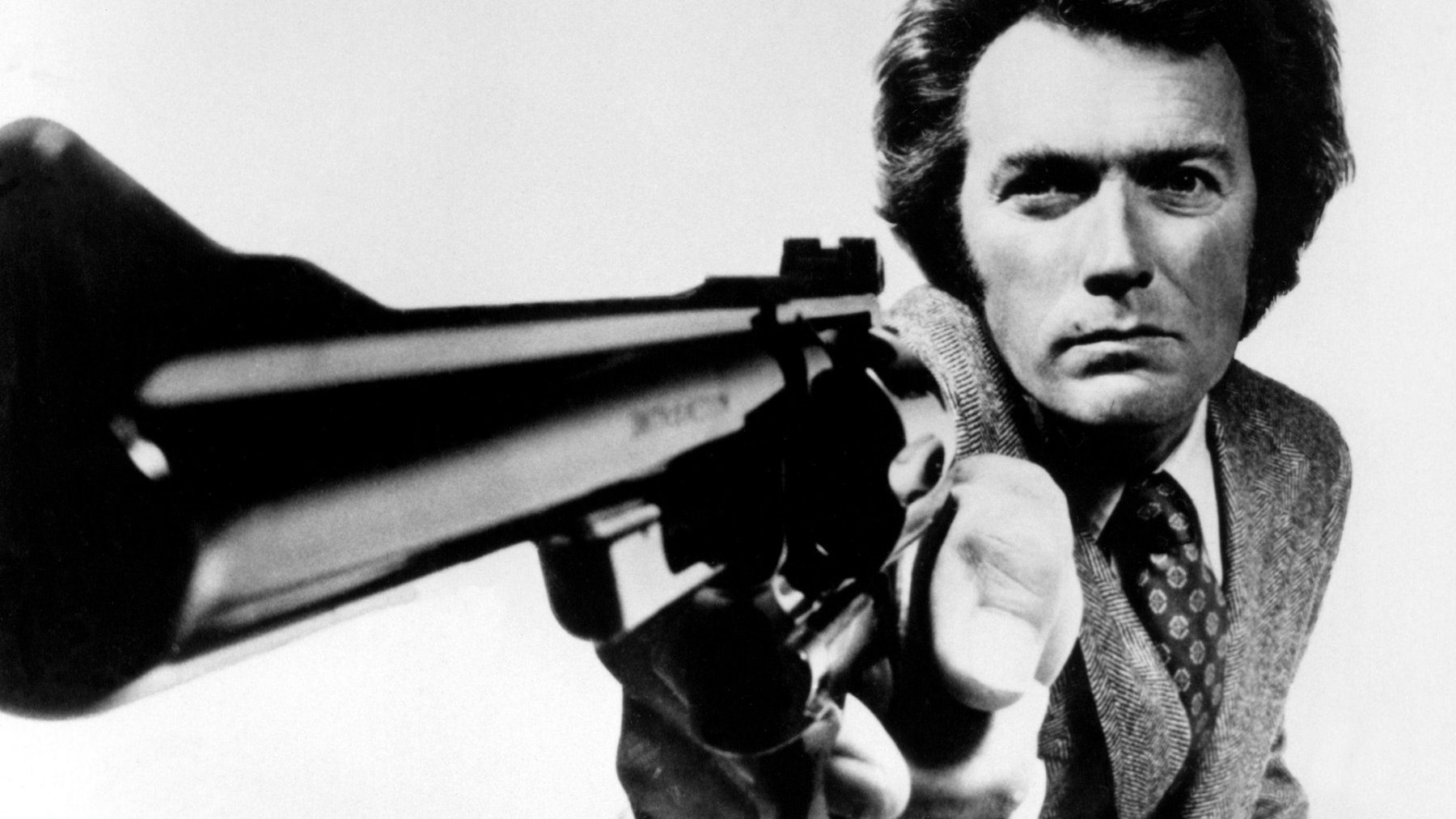 Clint Eastwood holding a gun HD Wallpaper