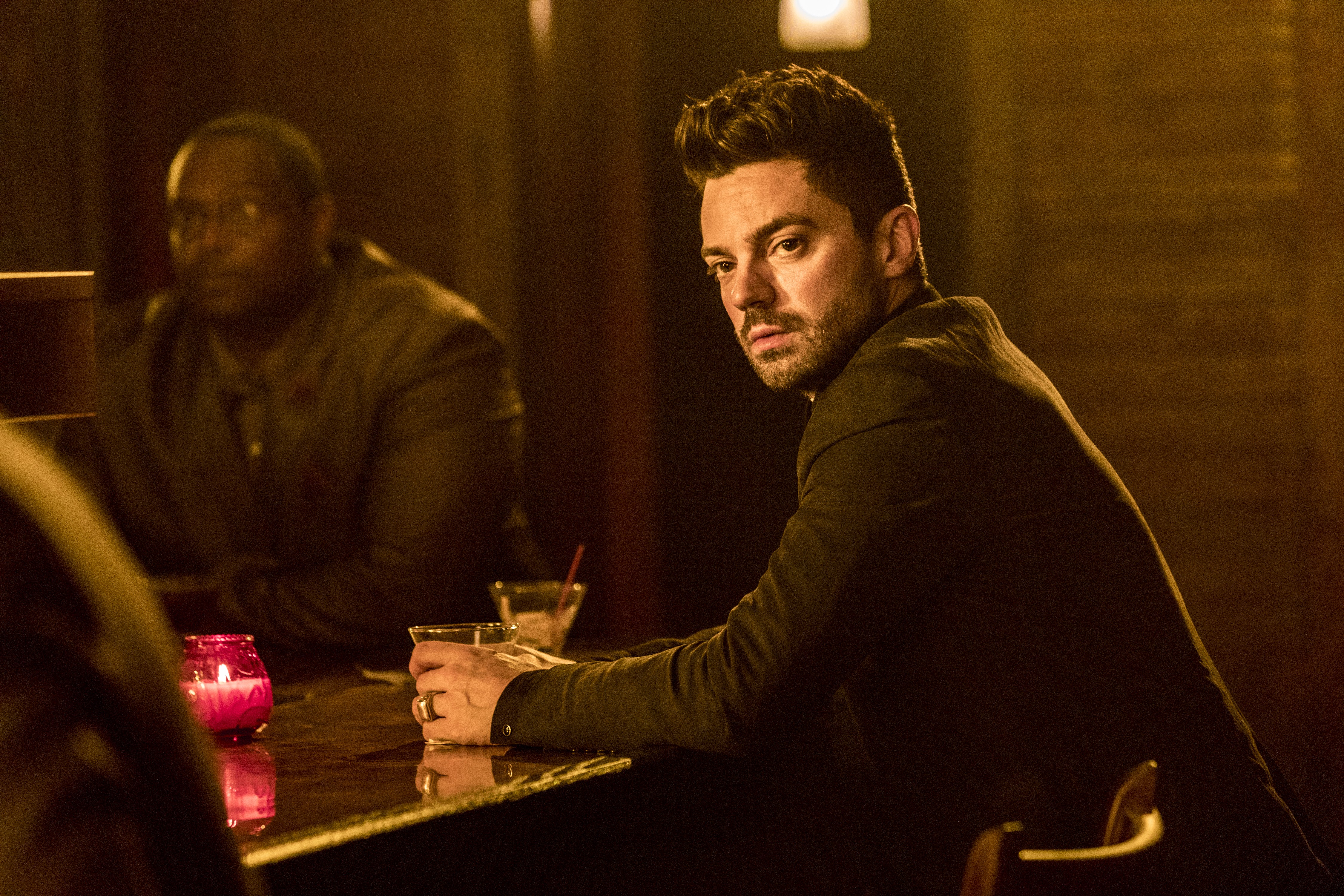 Dominic Cooper in a dimly lit bar HD Wallpaper