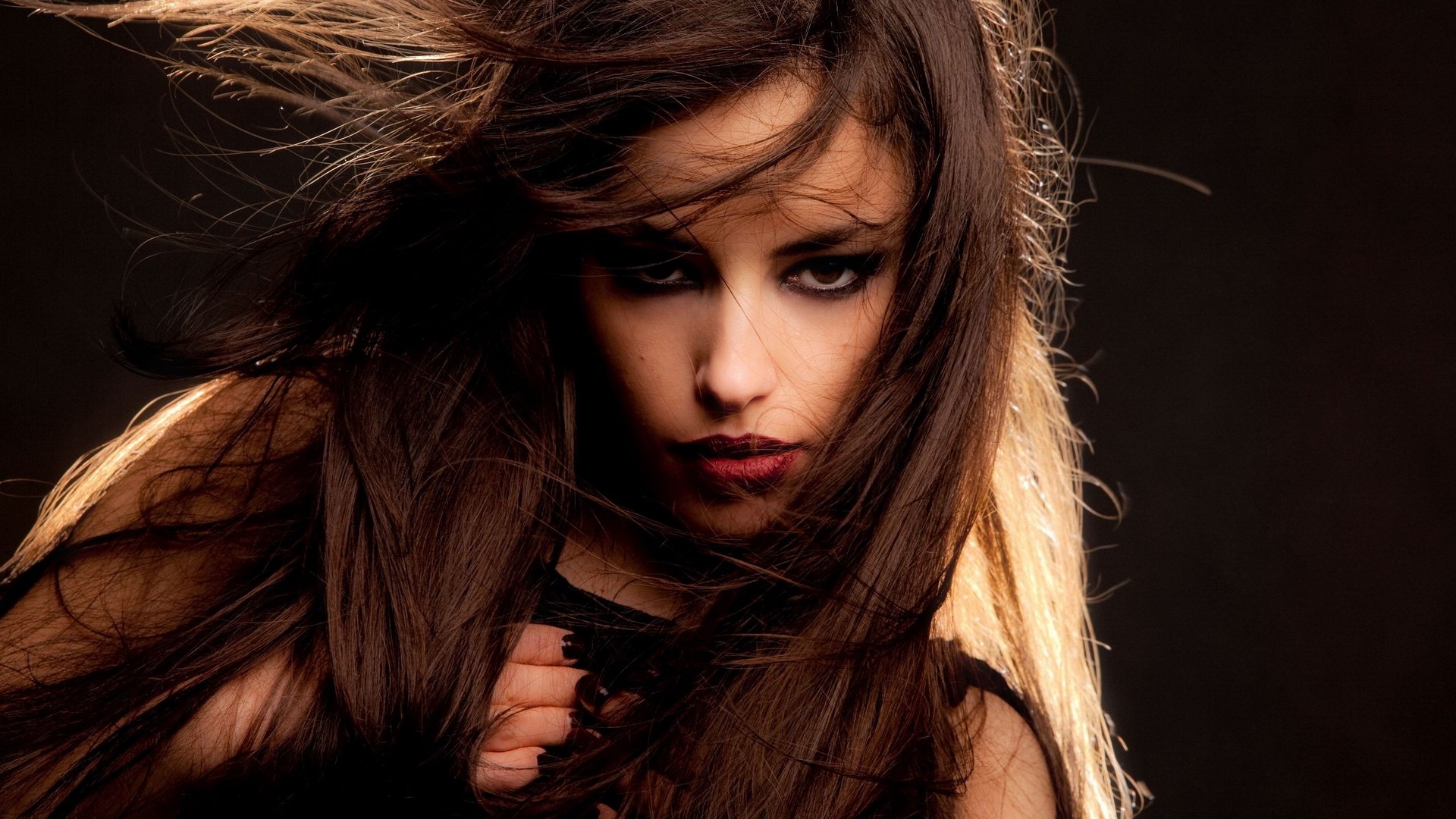 Woman with dark hair and dramatic makeup HD Wallpaper