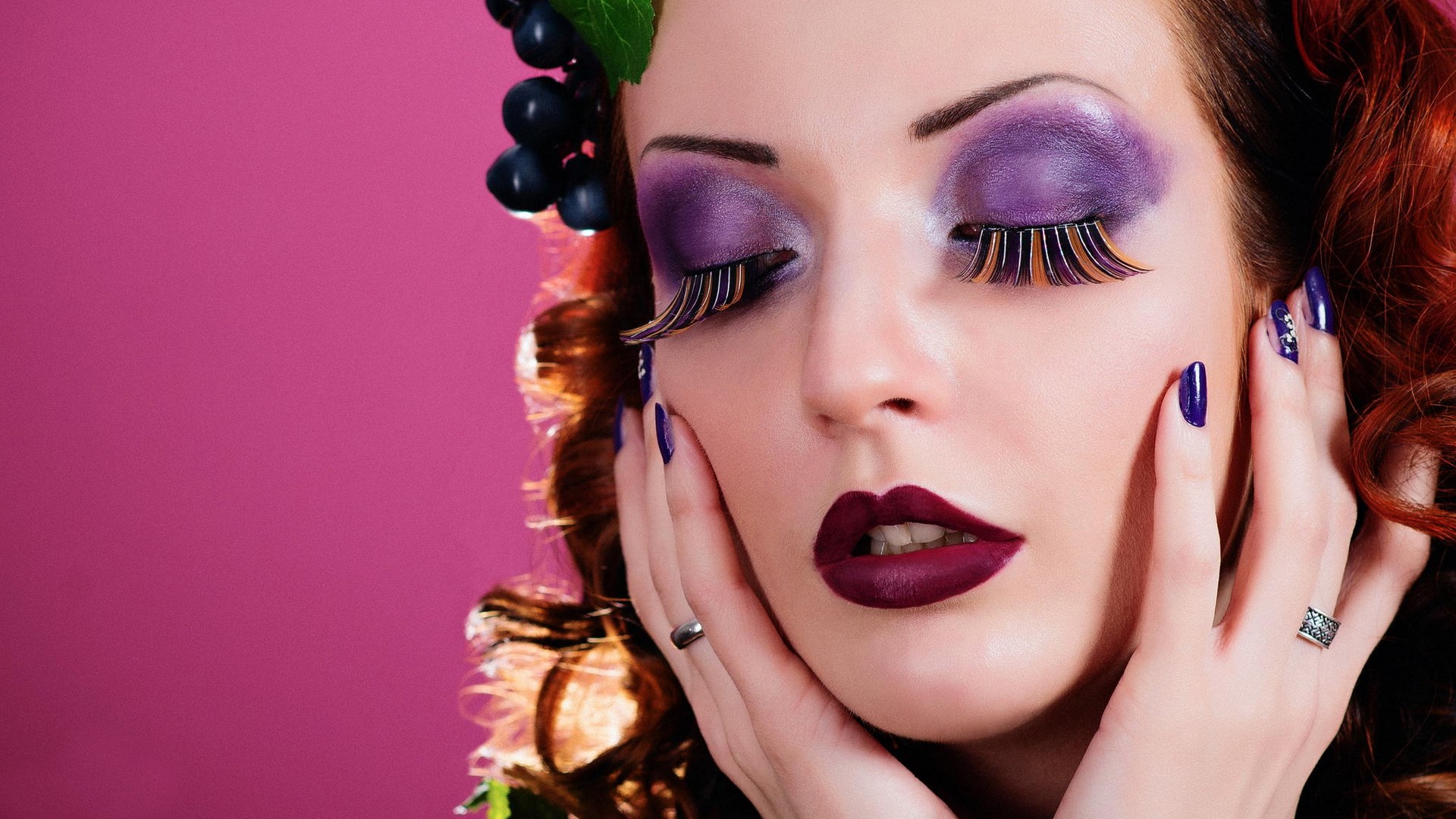 Woman with dramatic purple makeup and grapes HD Wallpaper