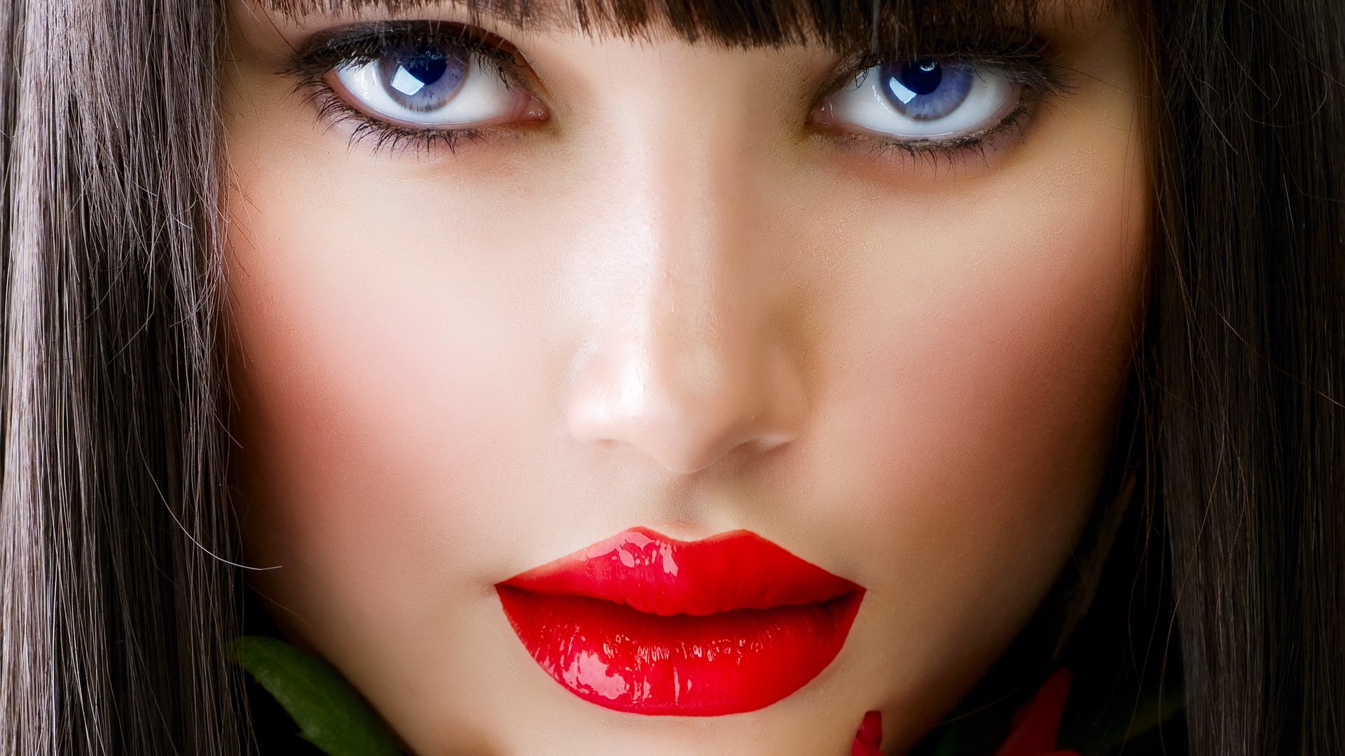 Close-up of a woman's face with blue eyes and red lips HD Wallpaper