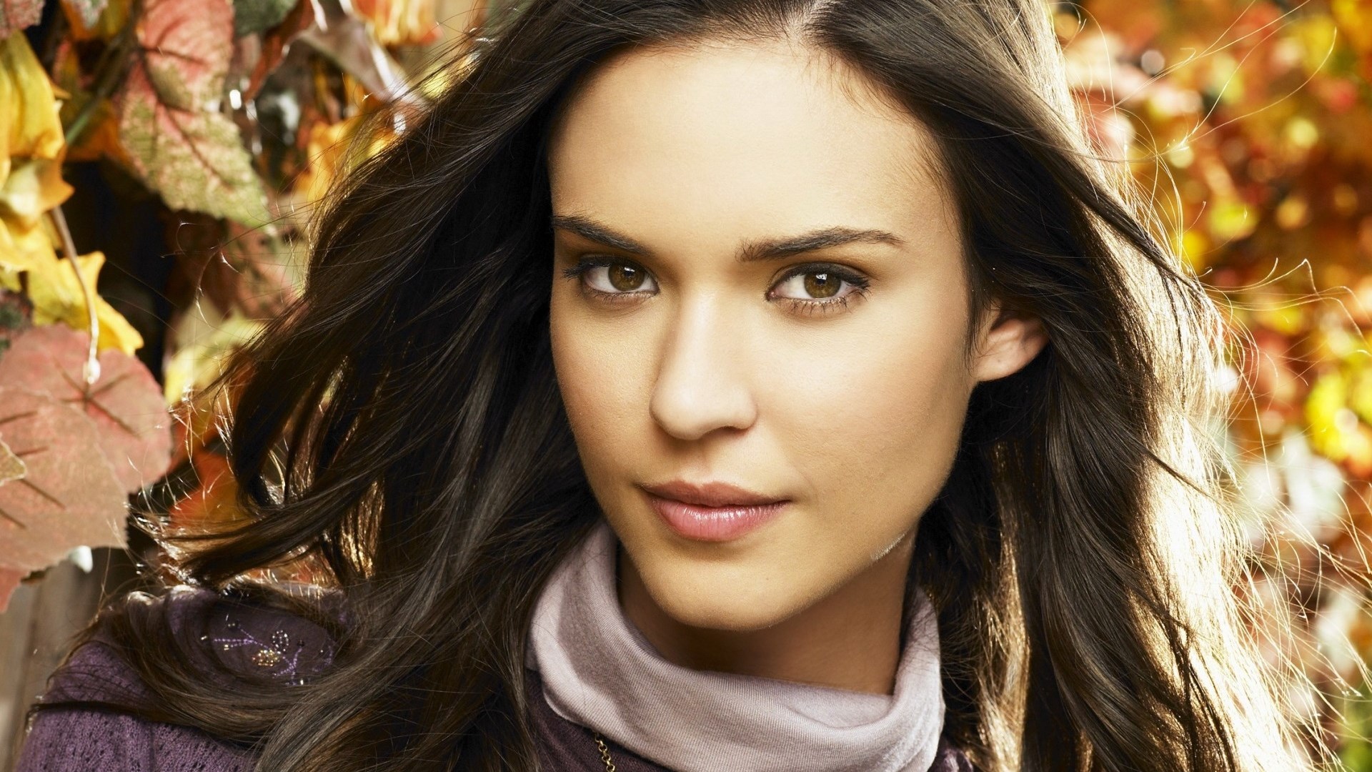 Woman with long dark hair and autumn leaves HD Wallpaper