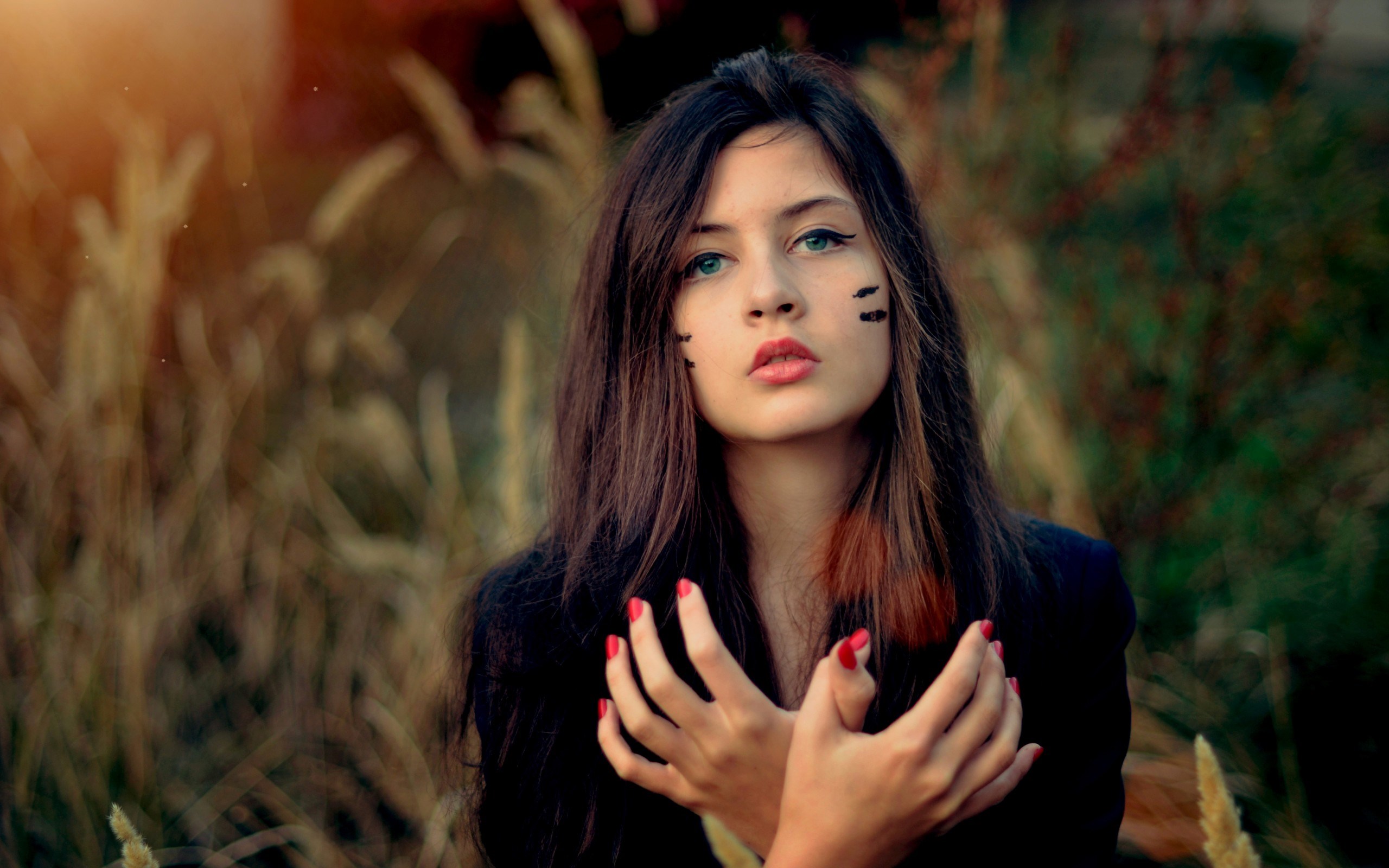 Young woman with face paint and red nails HD Wallpaper