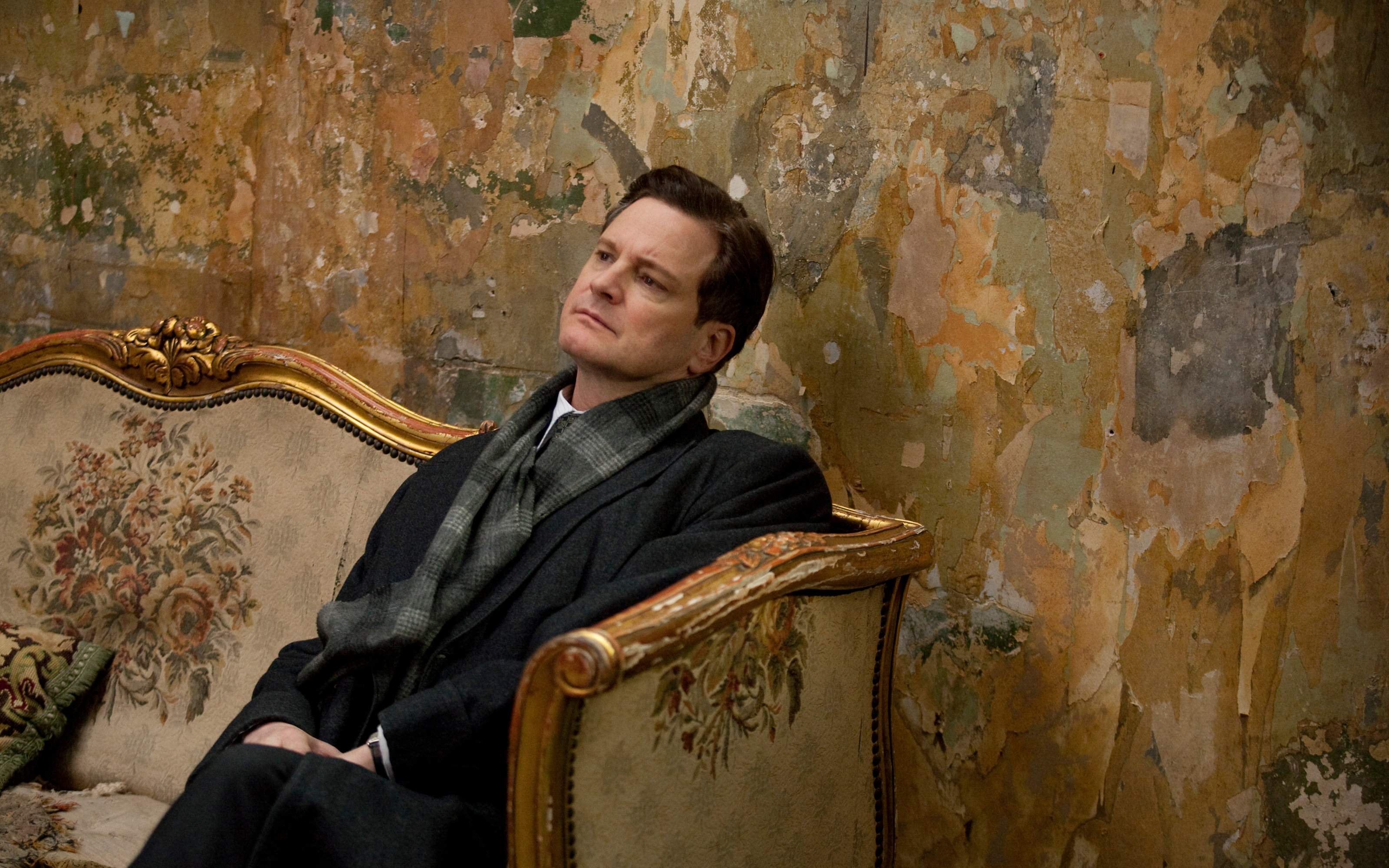 Colin Firth sitting on a couch HD Wallpaper