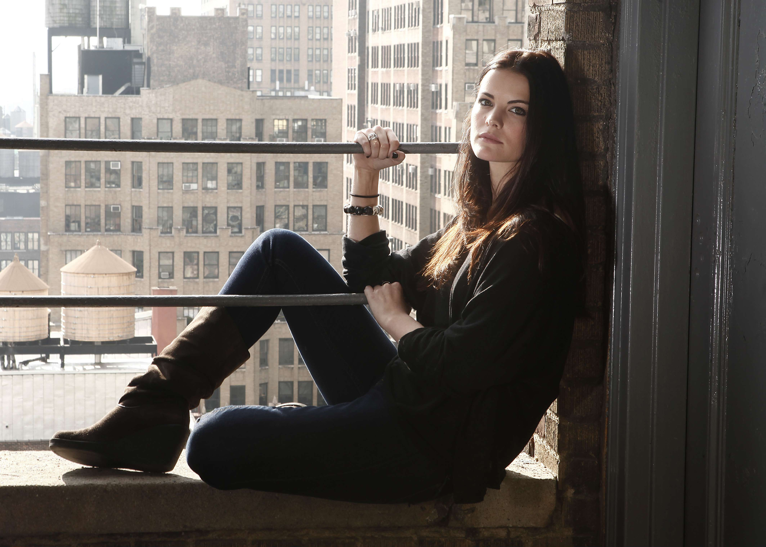 Jaimie Alexander sitting on a ledge HD Wallpaper