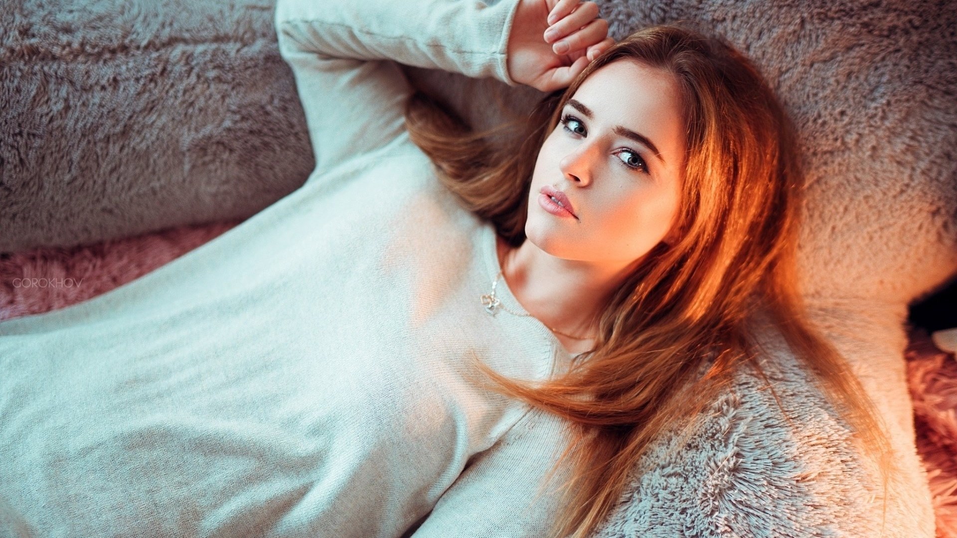 Woman lying on a fluffy surface HD Wallpaper