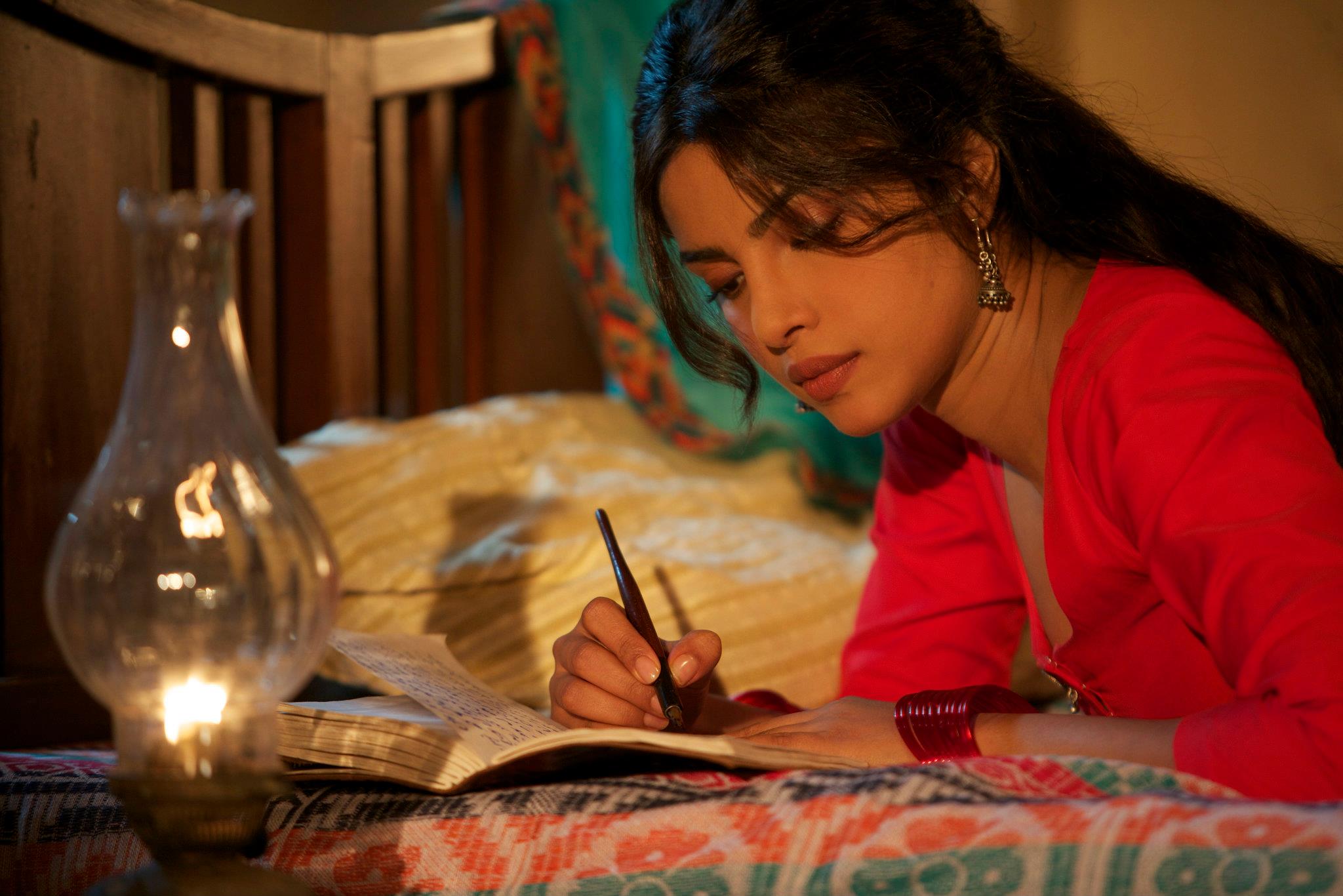 Priyanka Chopra writing in a journal HD Wallpaper