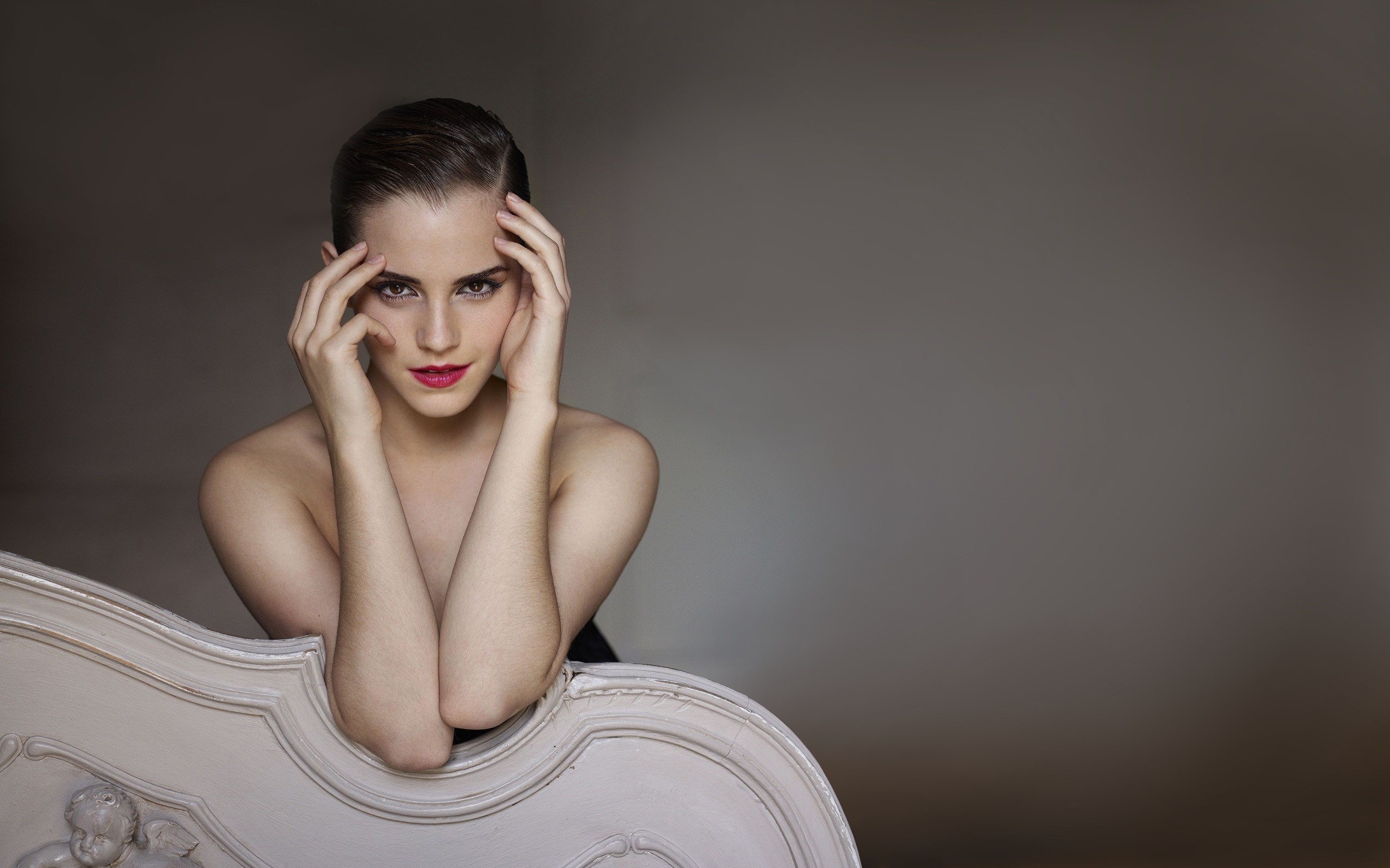 Emma Watson posing on a chaise lounge HD Wallpaper