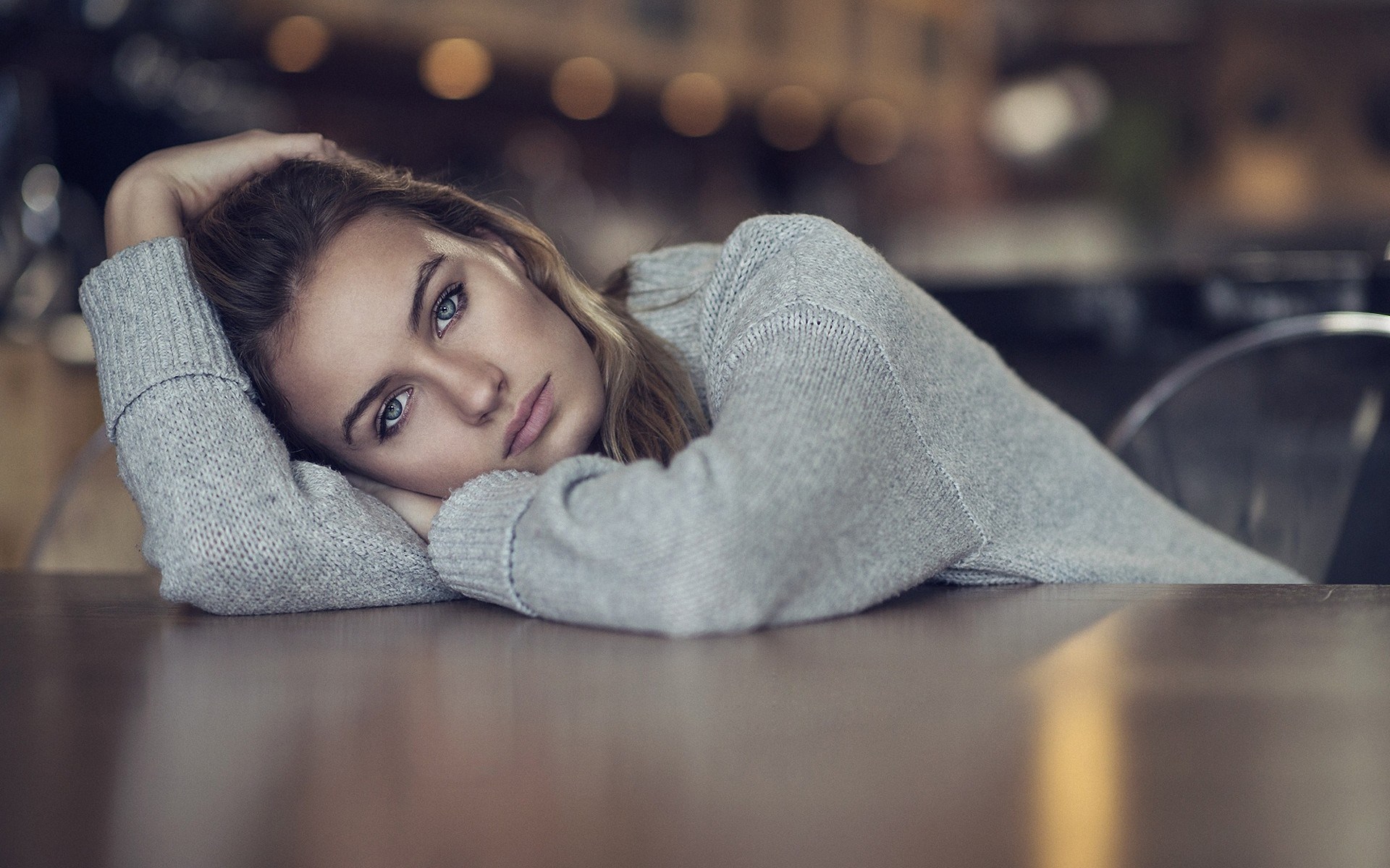 Woman resting her head on a table HD Wallpaper