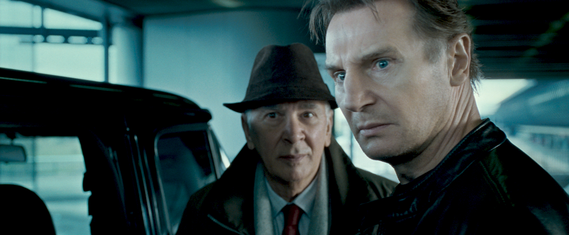 Liam Neeson and an older man in a car HD Wallpaper