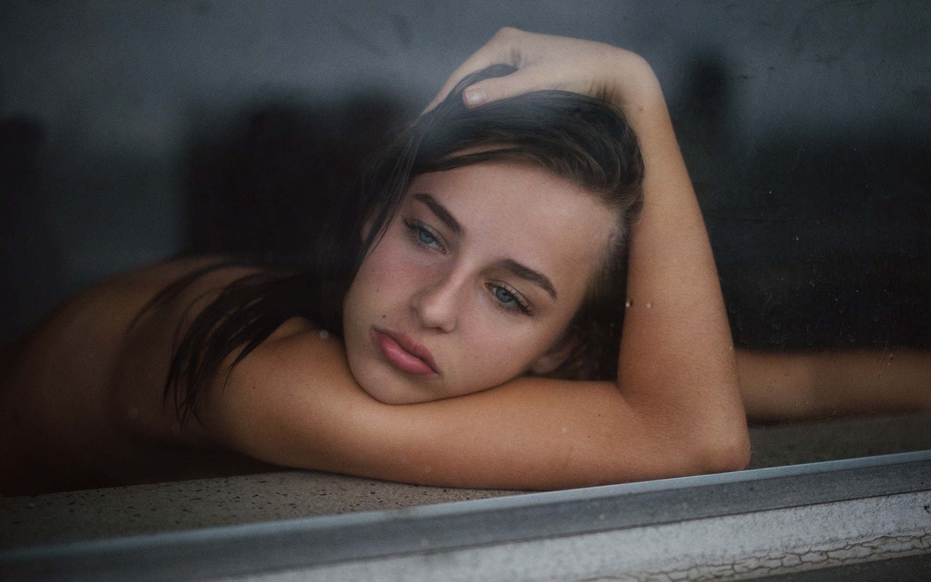 Young woman resting her head on her arms HD Wallpaper