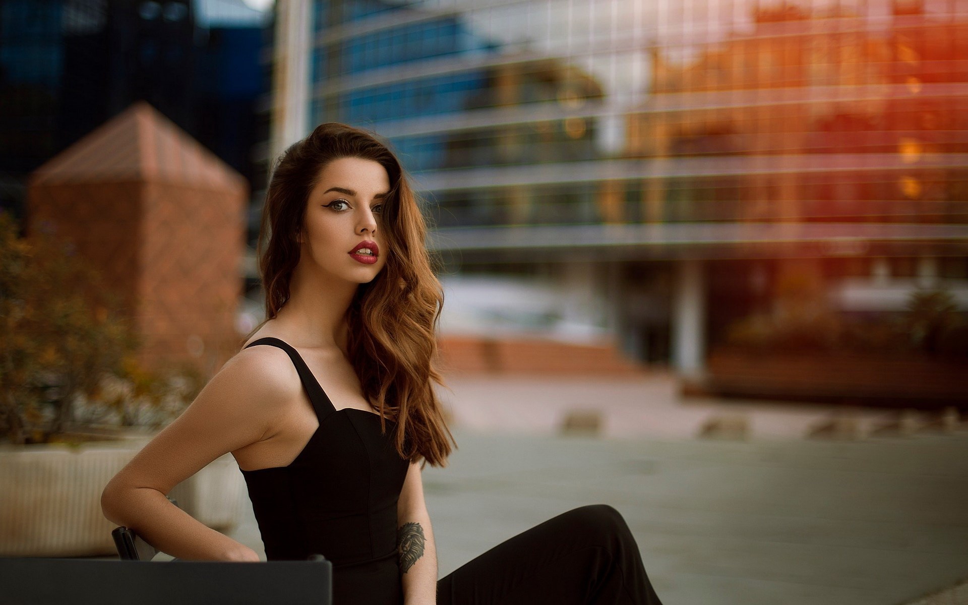 Woman in black dress posing outdoors HD Wallpaper
