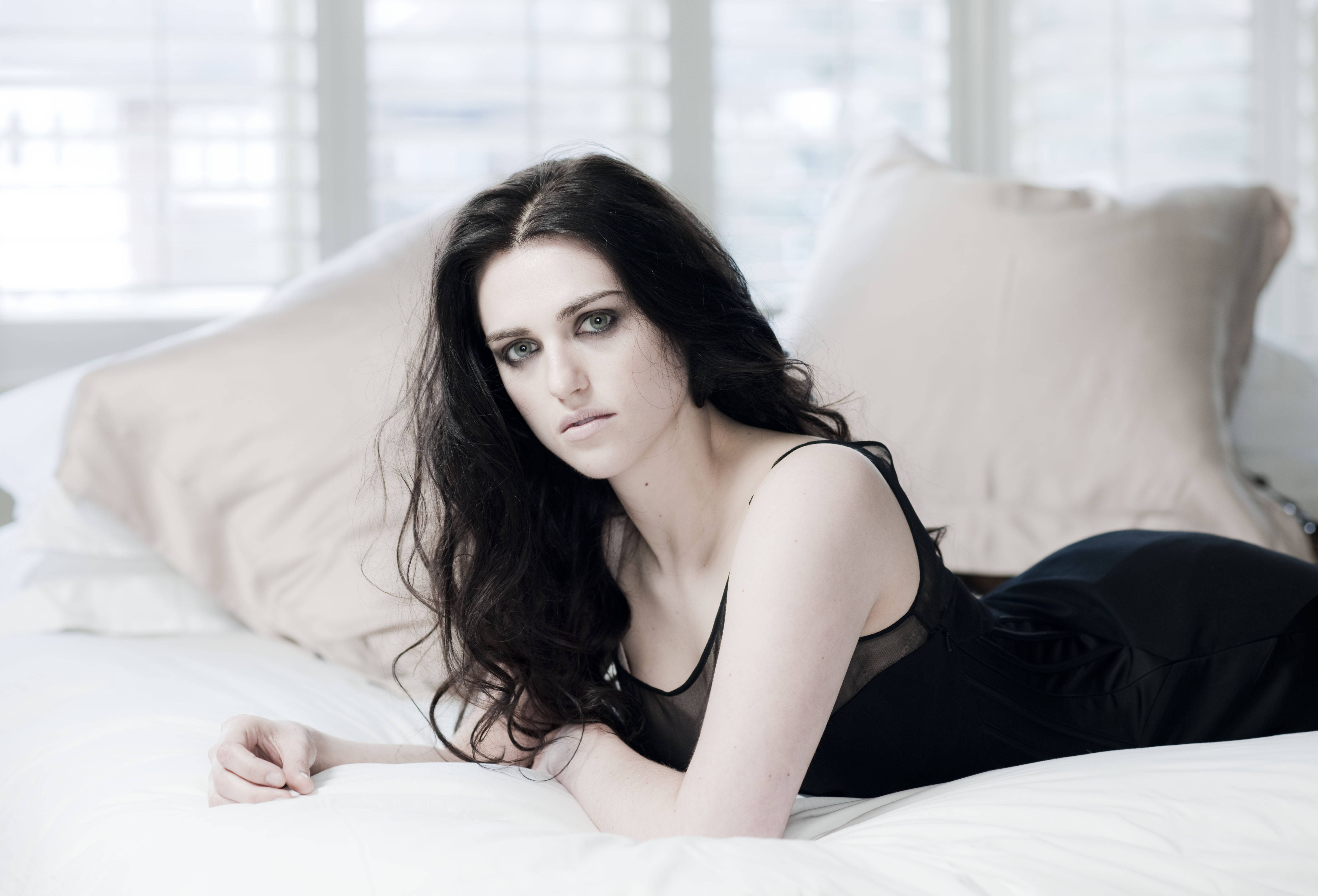 Katie McGrath lying on a bed HD Wallpaper