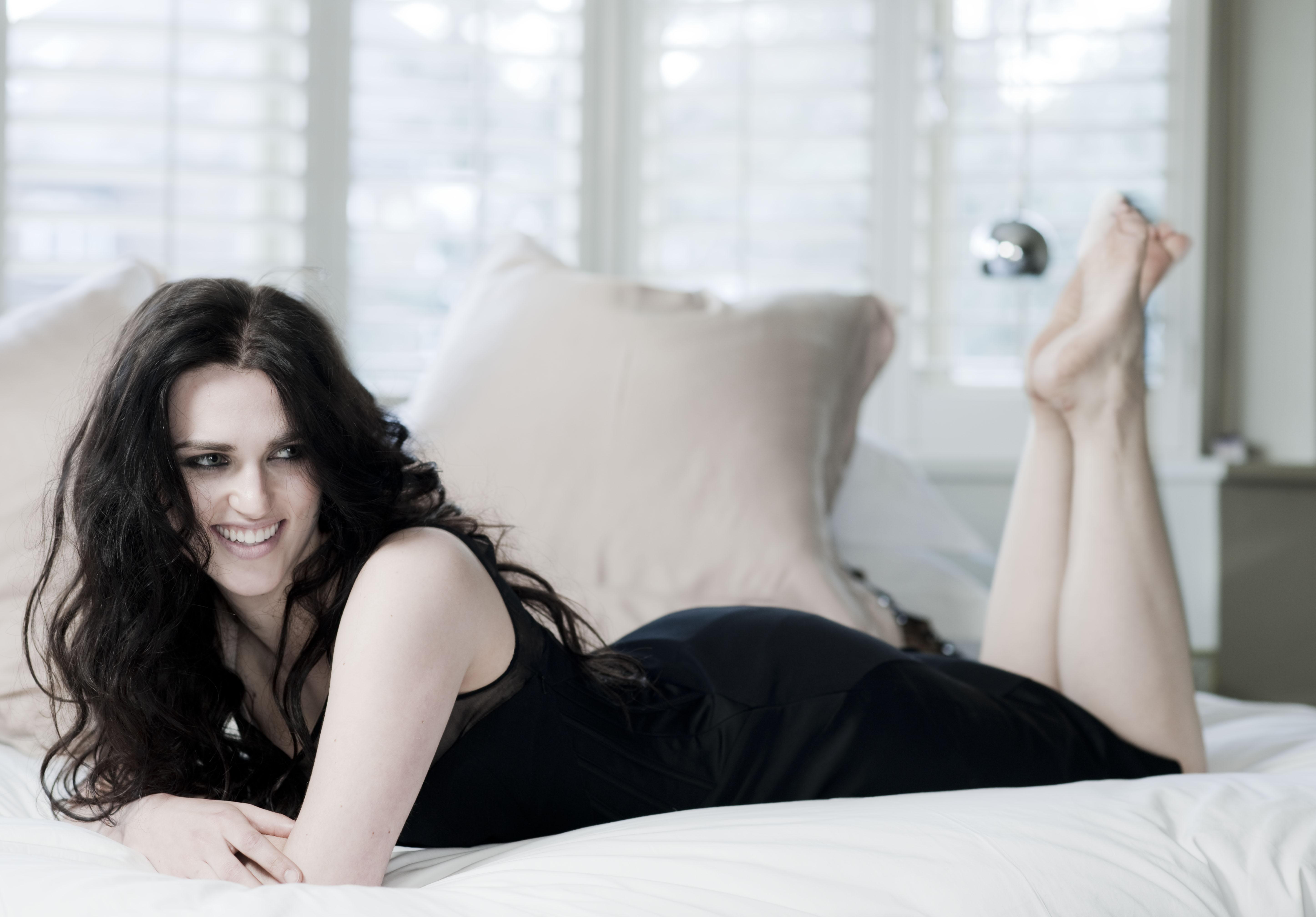Katie McGrath lying on a bed HD Wallpaper
