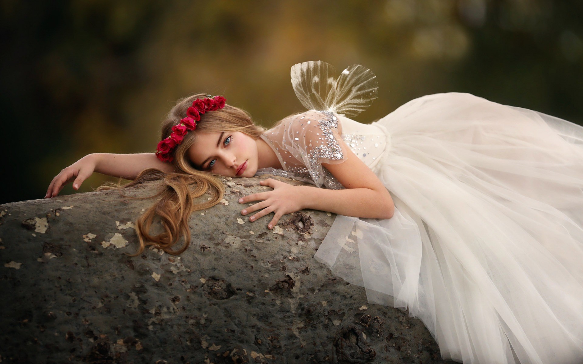 Girl in fairy costume lying on a tree trunk HD Wallpaper
