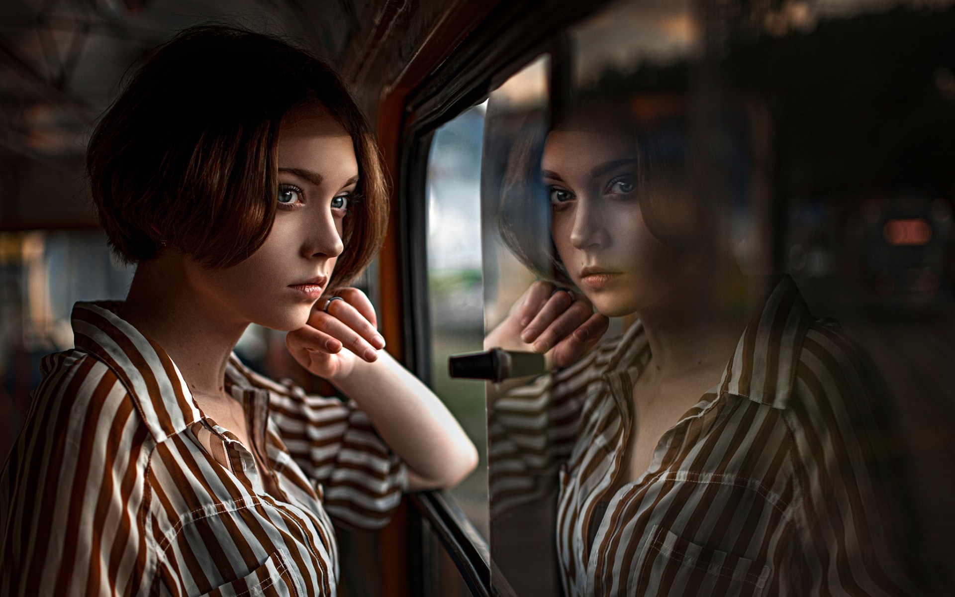 Woman looking out a window with reflection HD Wallpaper