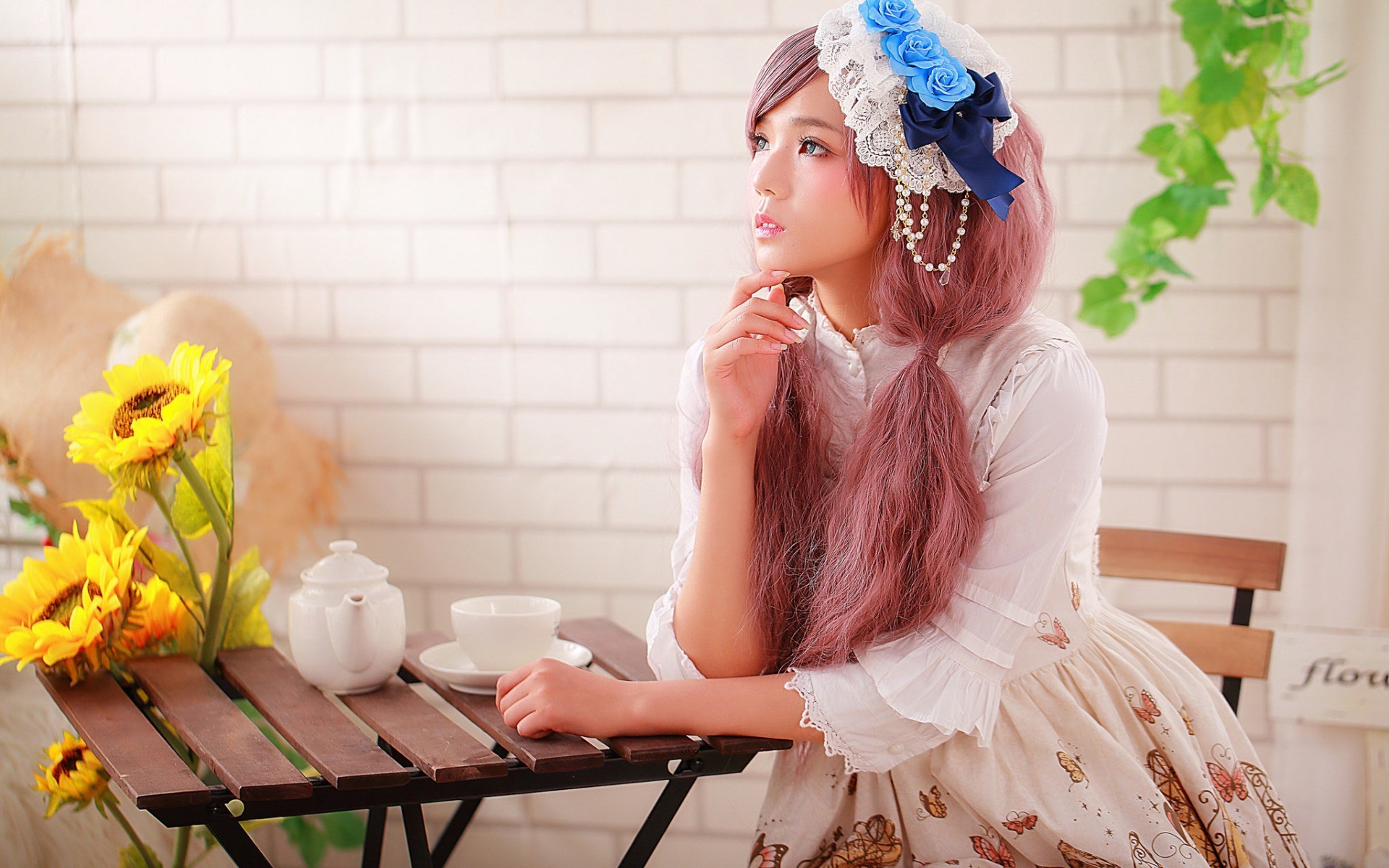 Woman in Lolita dress with sunflowers and tea set HD Wallpaper