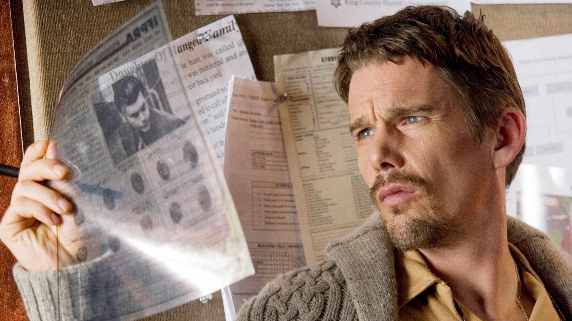 Ethan Hawke examines newspaper clippings HD Wallpaper