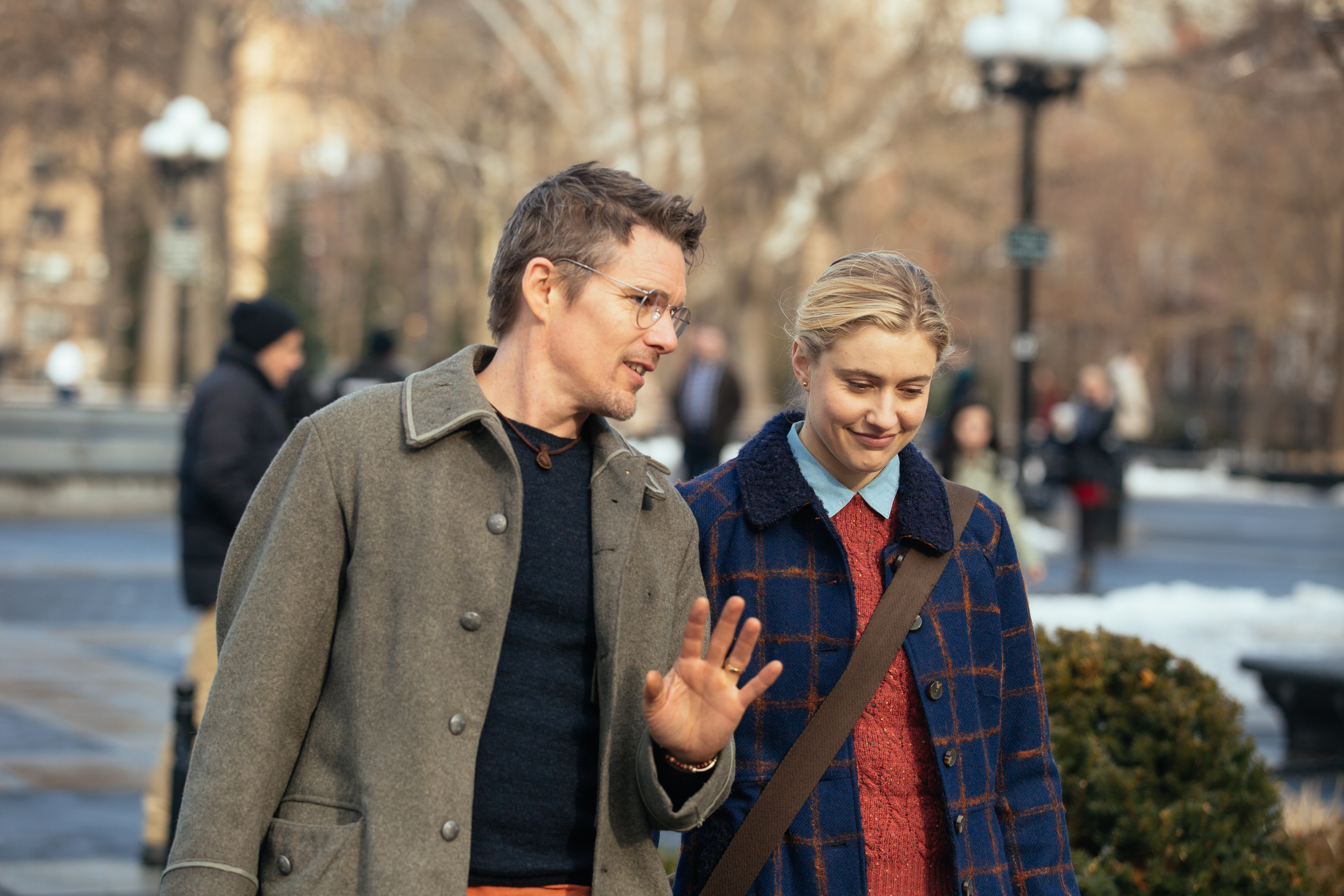 Ethan Hawke and Greta Gerwig walking in a park HD Wallpaper