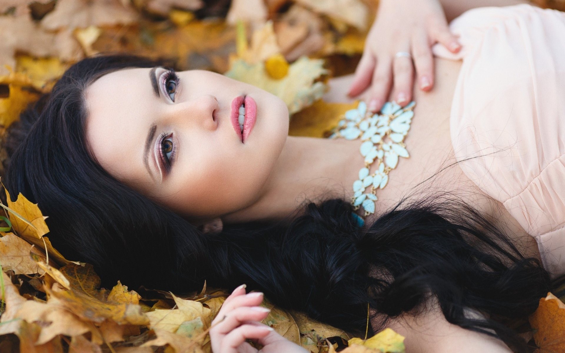Woman lying in autumn leaves HD Wallpaper
