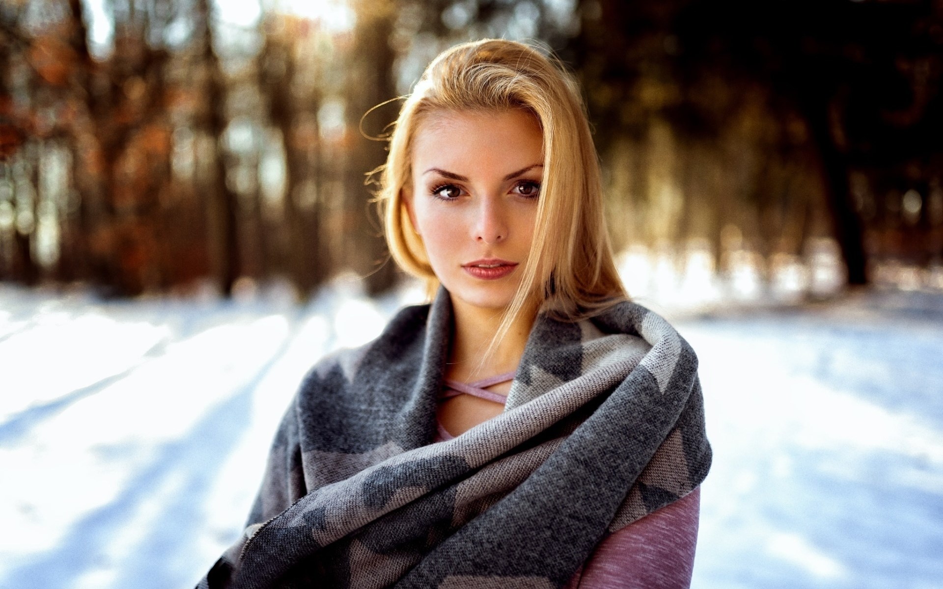 Woman wrapped in a scarf in a snowy forest HD Wallpaper