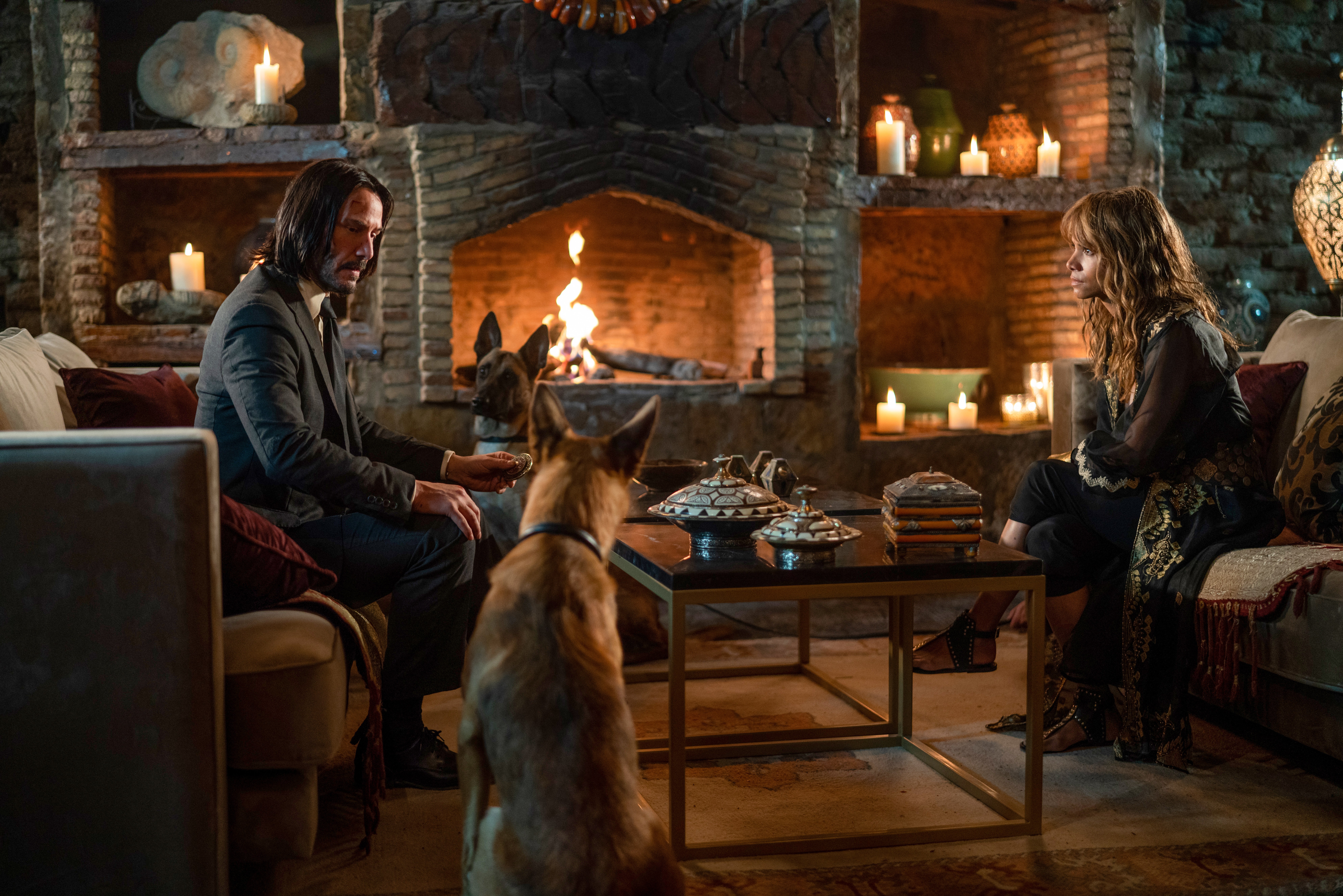 John Wick and Sofia with dogs in a room HD Wallpaper