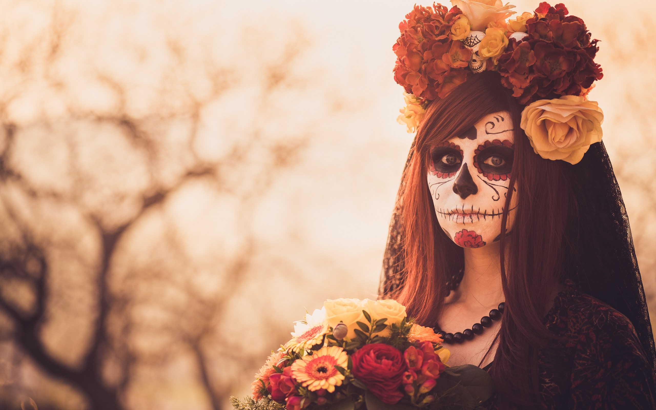 Woman in Day of the Dead makeup holding flowers HD Wallpaper