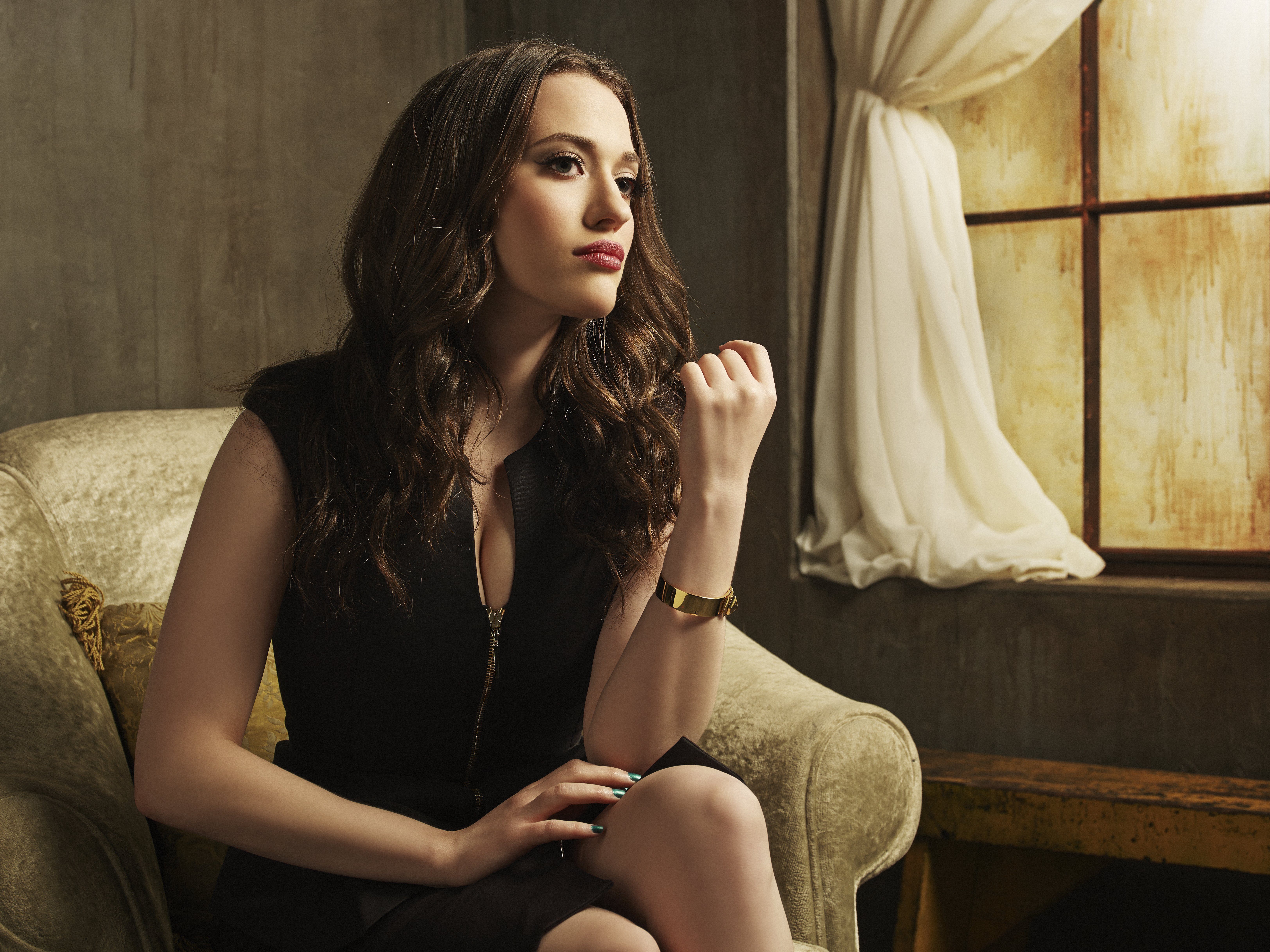 Kat Dennings sitting in a chair HD Wallpaper
