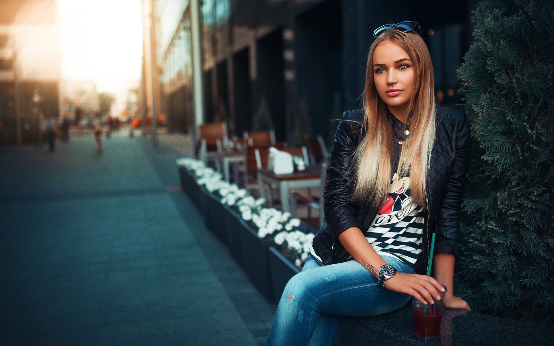 Woman in leather jacket and jeans holding a drink HD Wallpaper