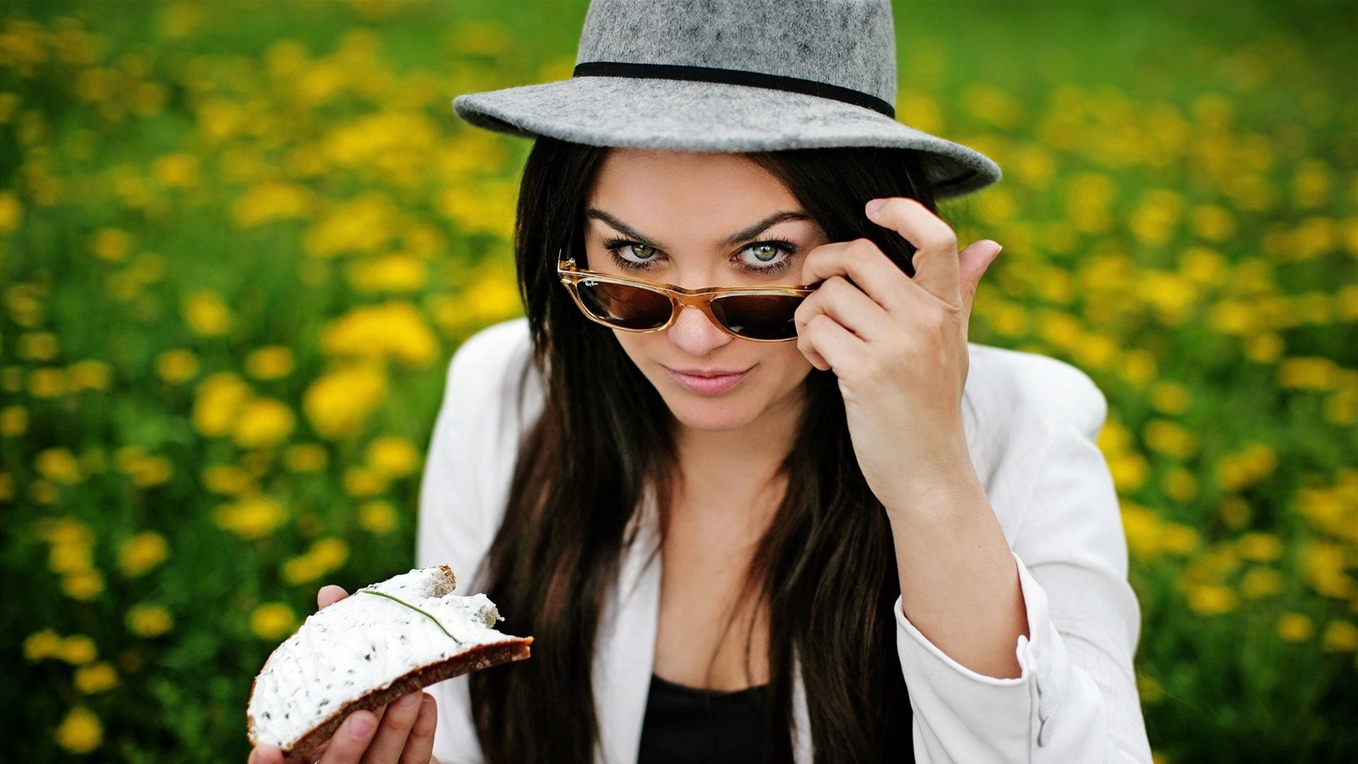 Woman in hat and sunglasses holding food HD Wallpaper