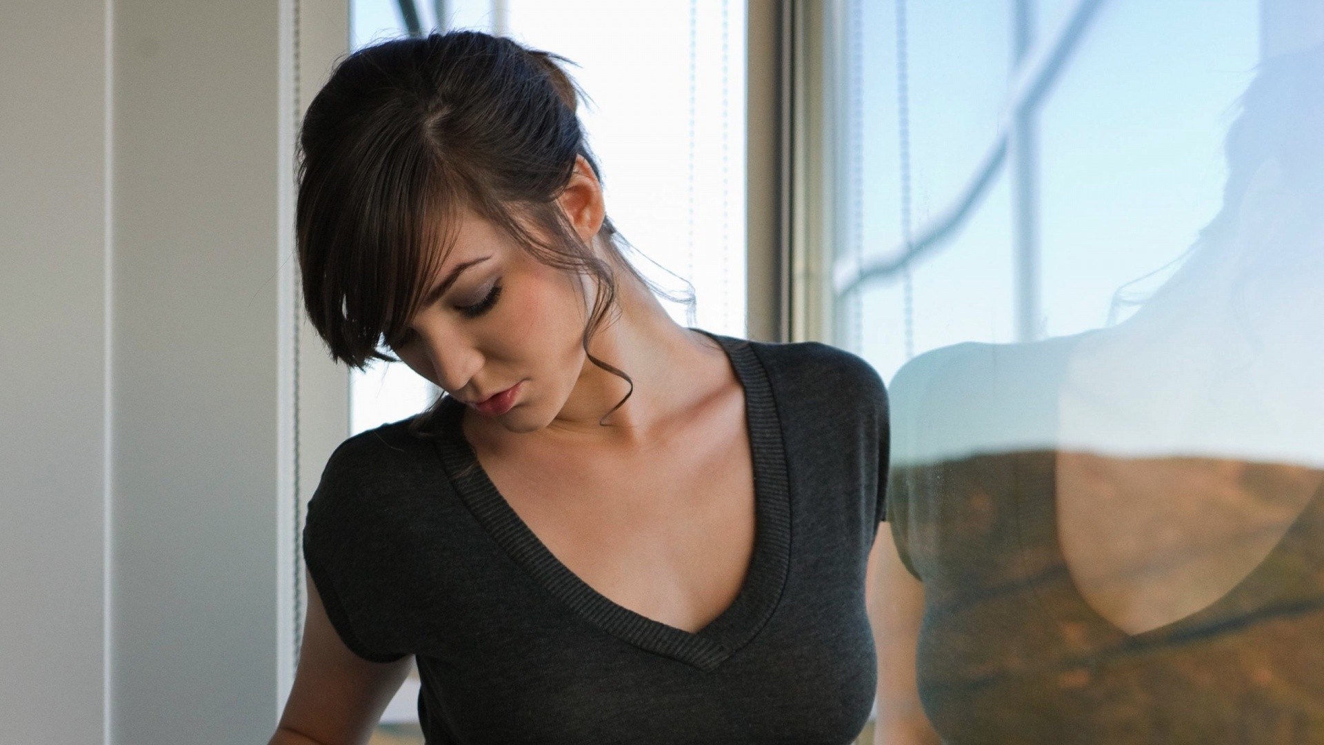 Woman looking down near window HD Wallpaper