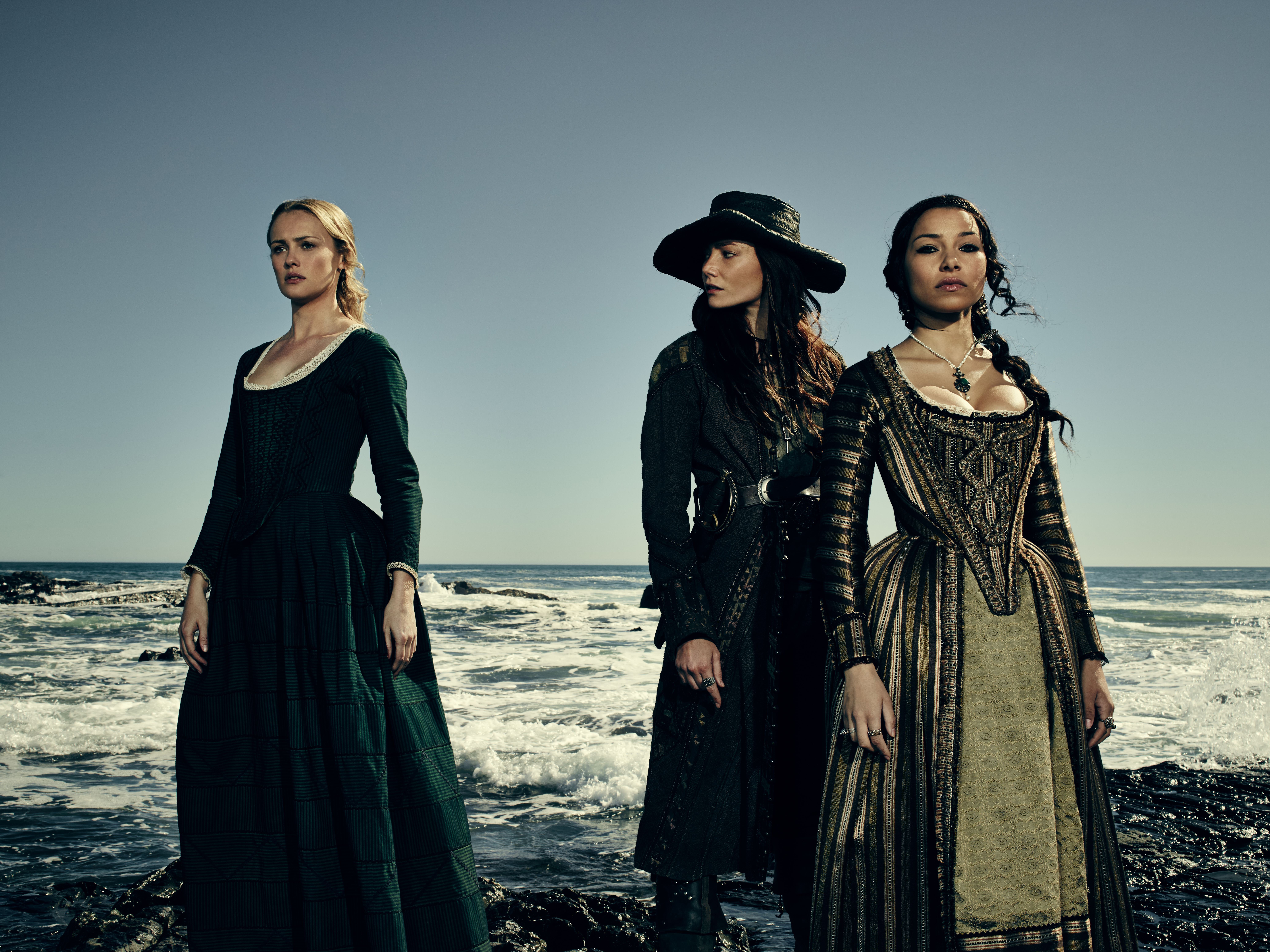 Hannah New and two women on a rocky shore HD Wallpaper