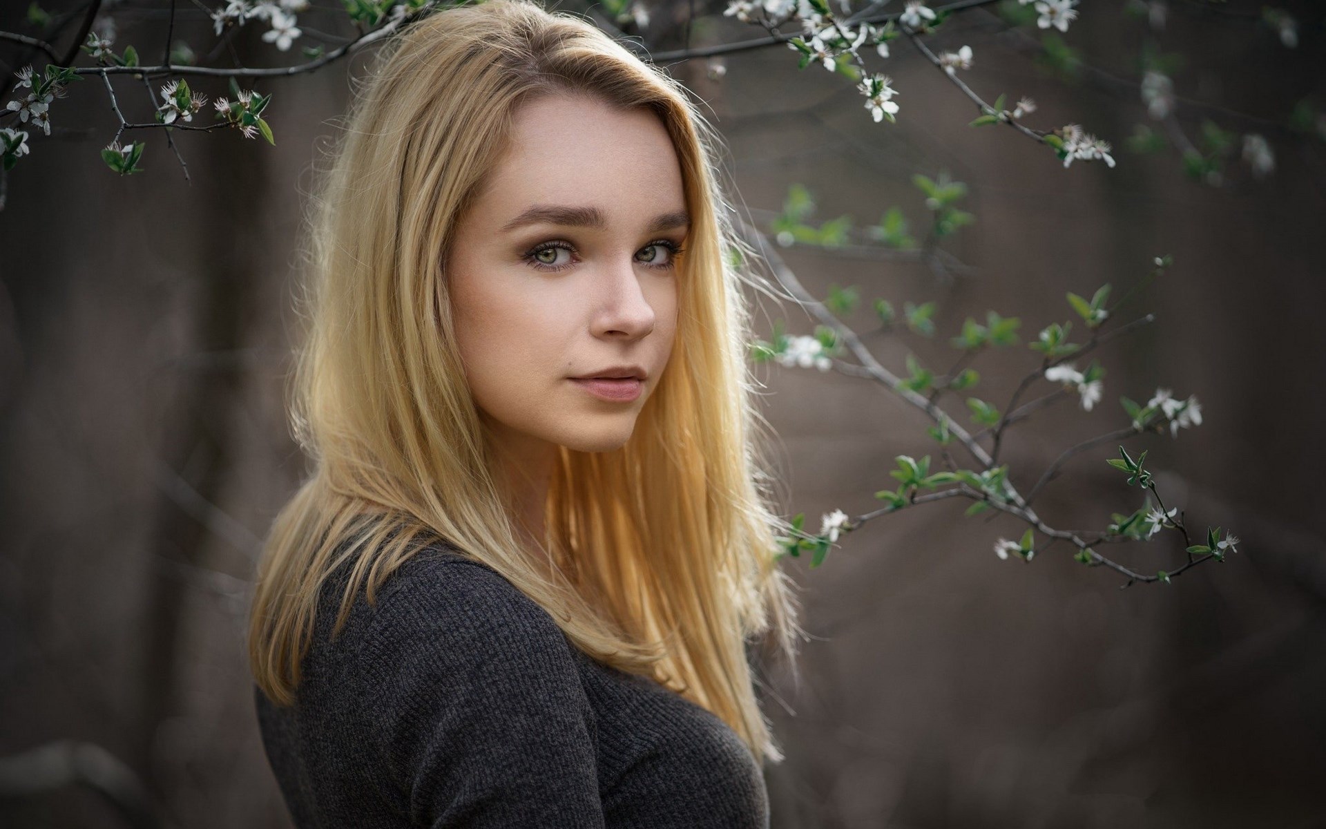 Woman with blonde hair near flowering branches HD Wallpaper