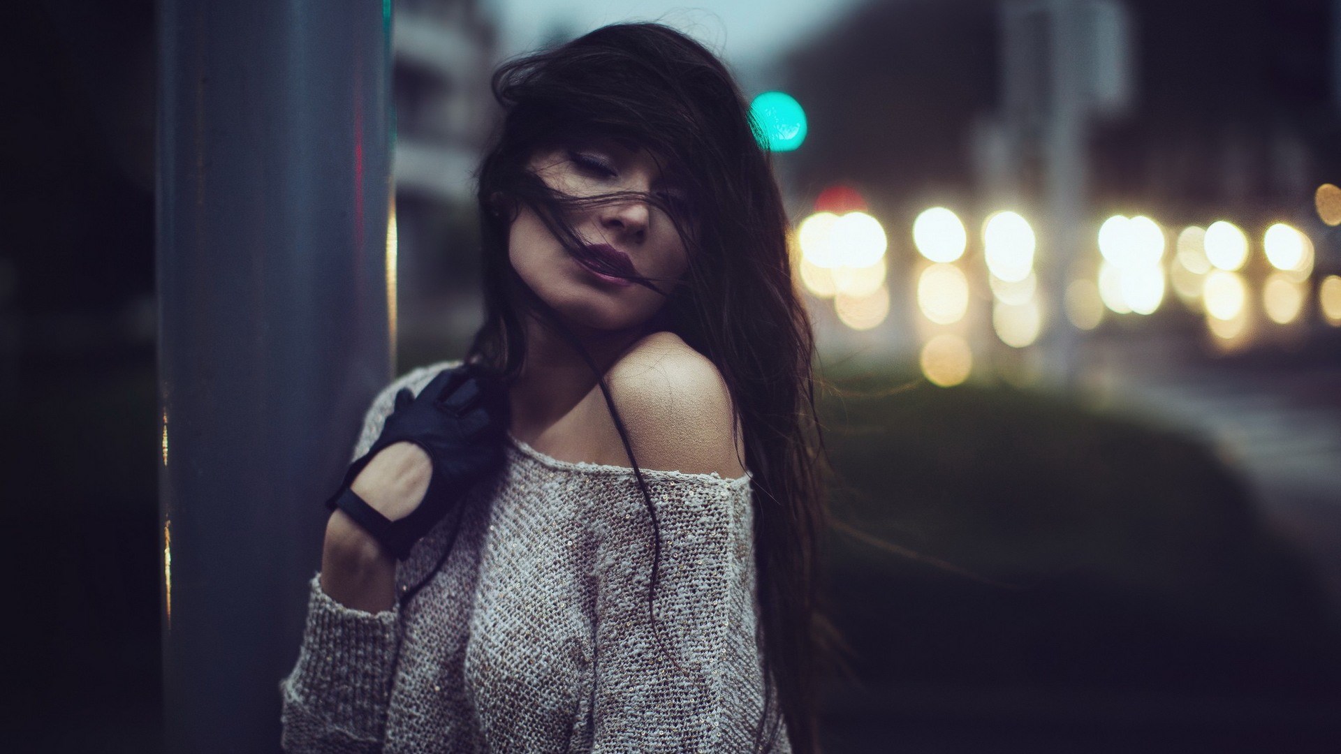 Woman with dark hair and black gloves at night HD Wallpaper