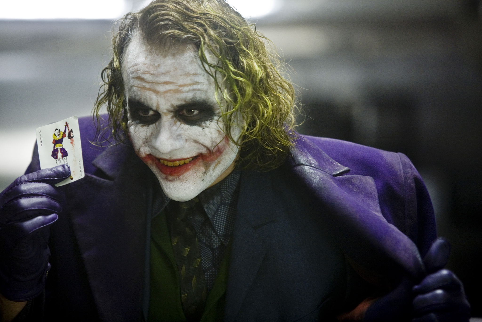 Heath Ledger as the Joker holding a card HD Wallpaper