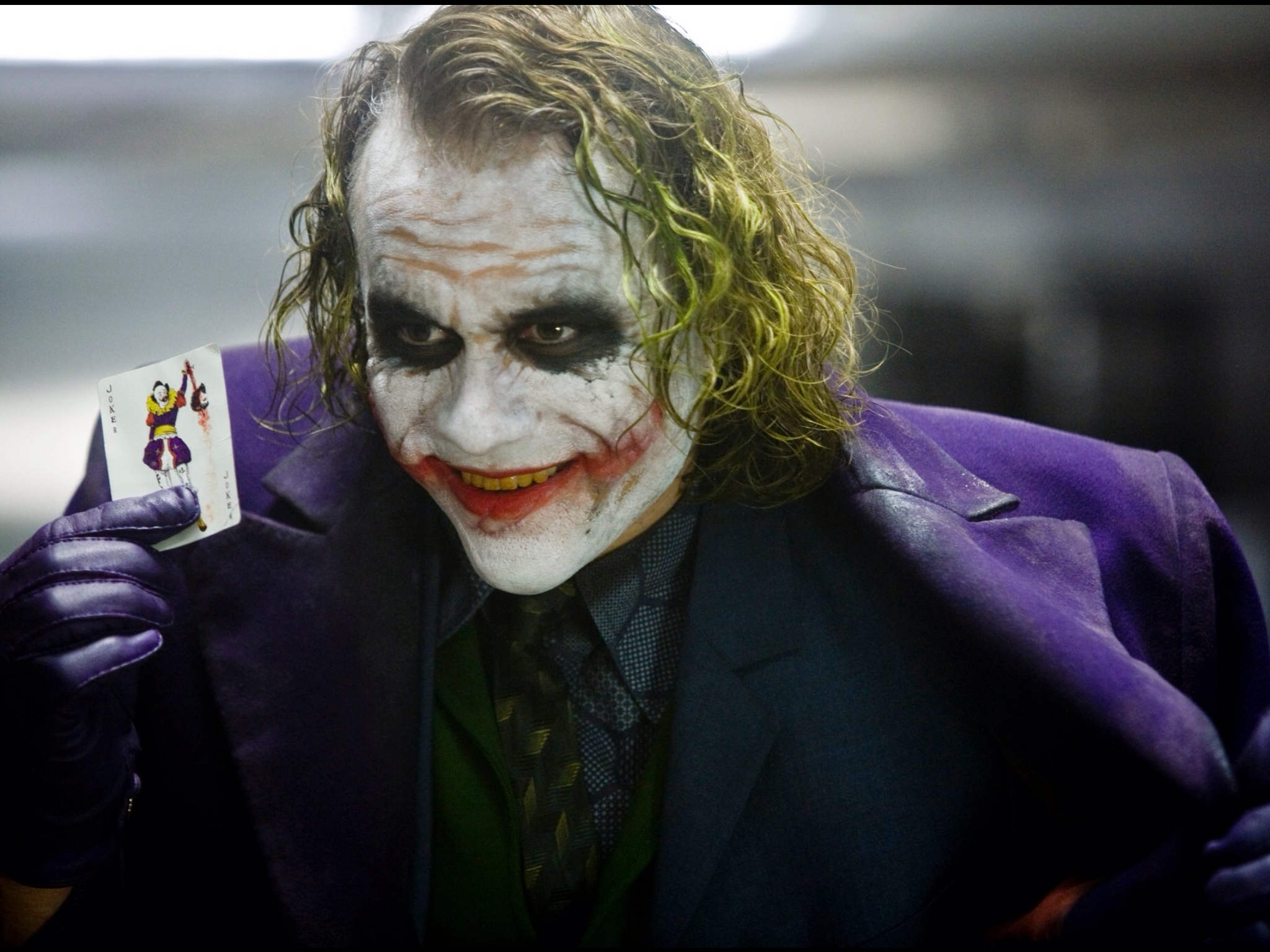 The Joker from The Dark Knight holding a card HD Wallpaper