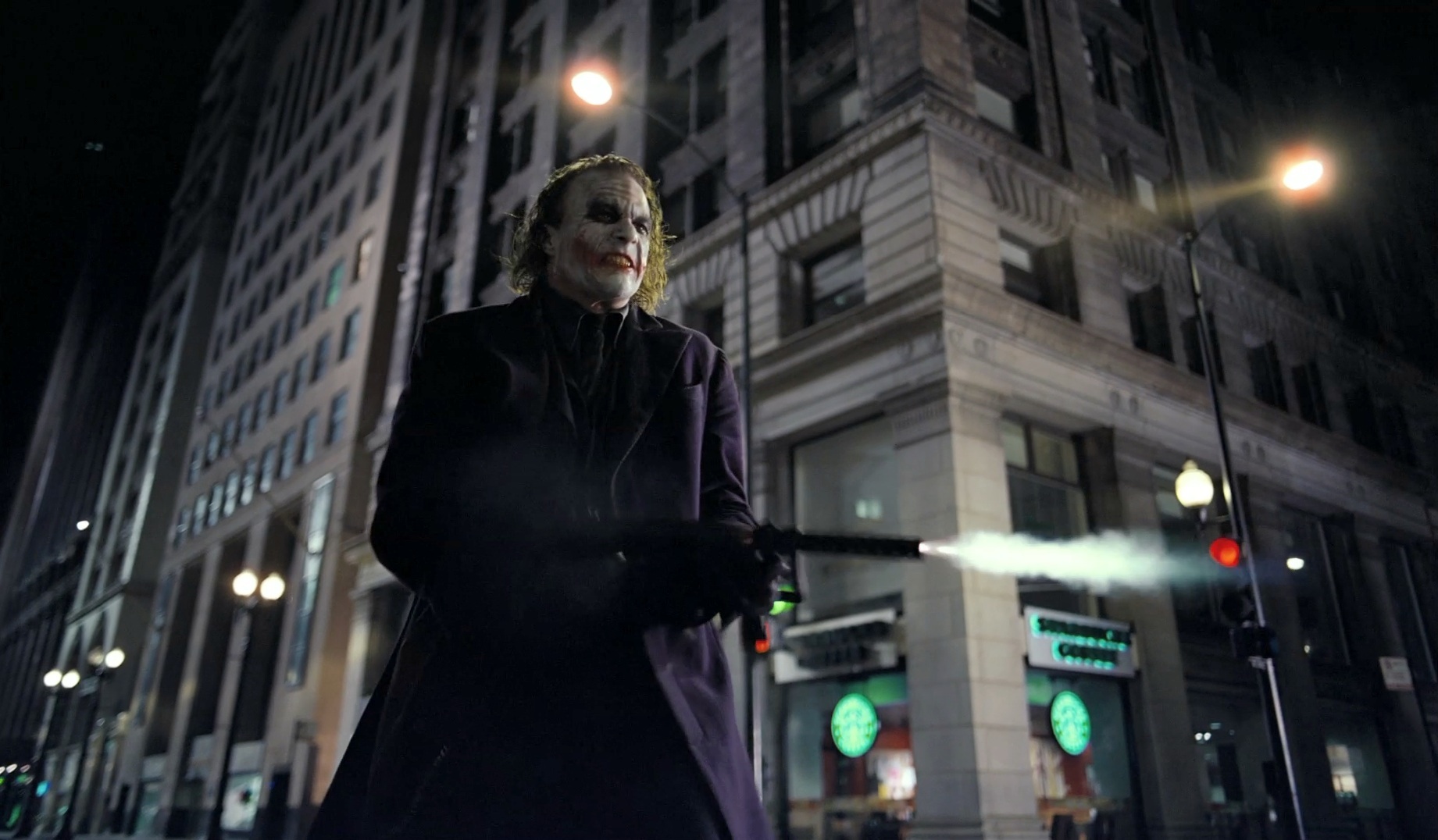 The Joker from The Dark Knight holding a gun HD Wallpaper