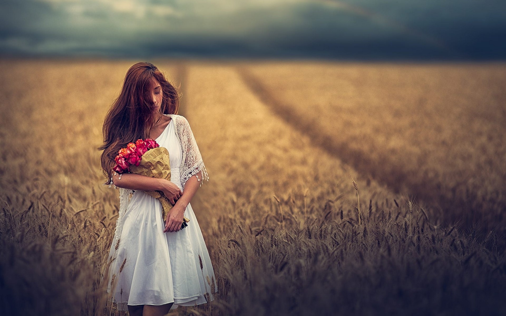 Woman in white dress holding flowers in a wheat field HD Wallpaper