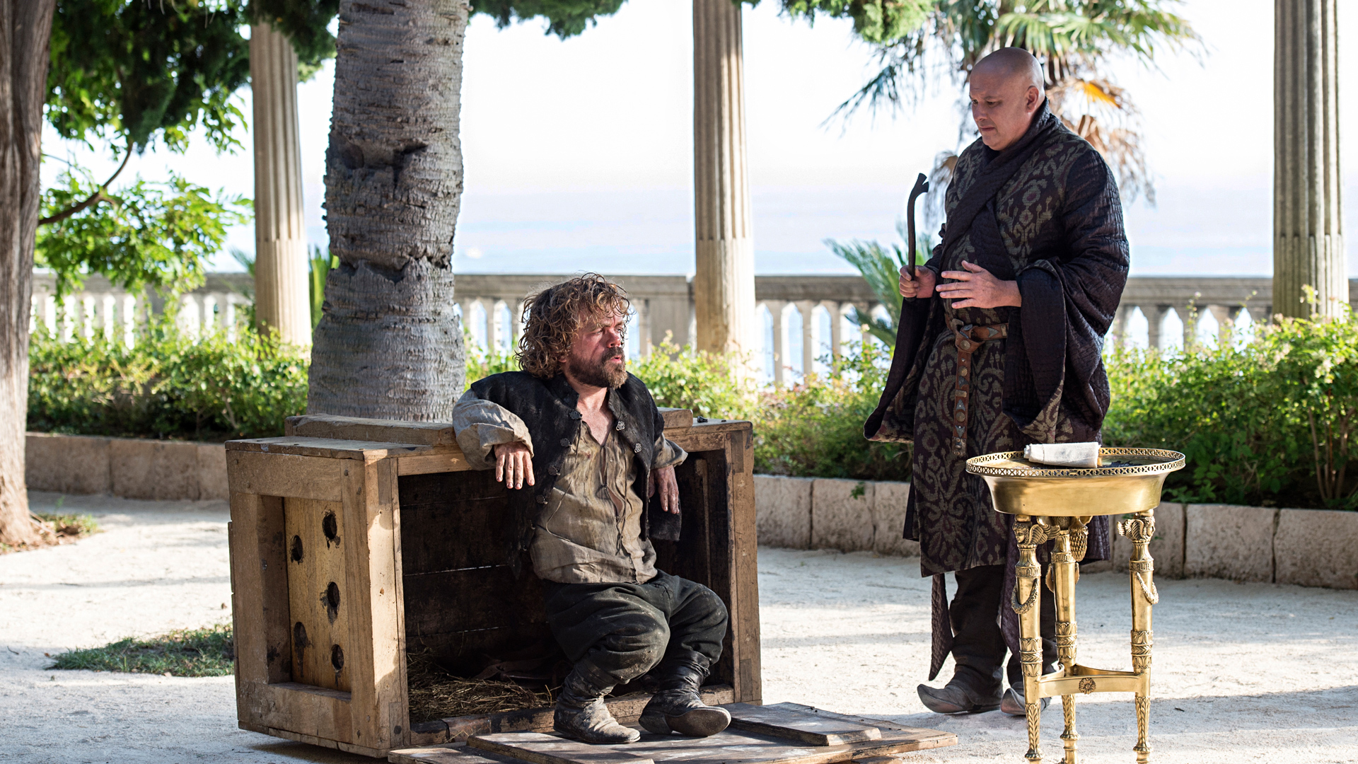 Tyrion Lannister and Lord Varys in a courtyard HD Wallpaper