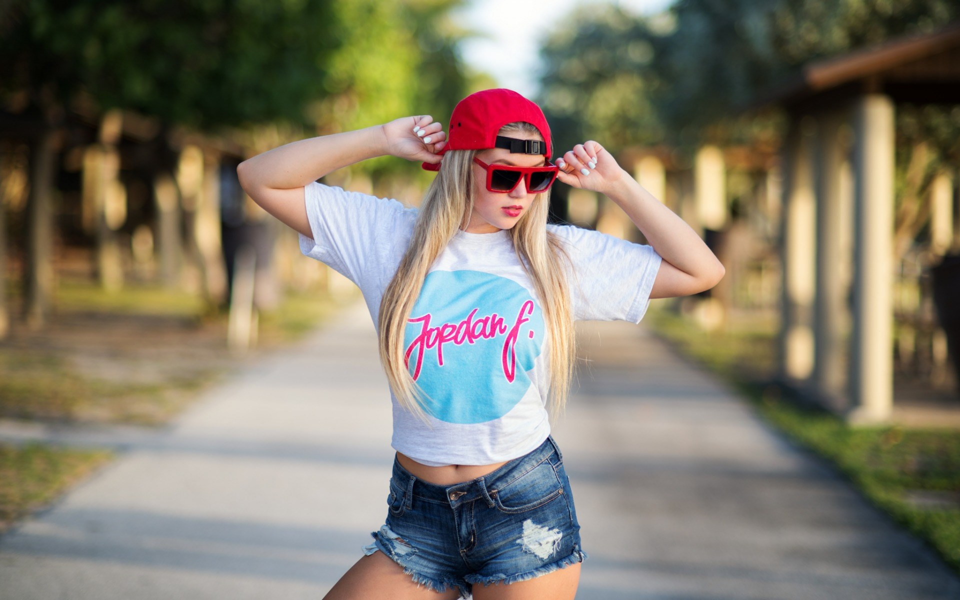 Woman in Jordan F. T-shirt and denim shorts HD Wallpaper