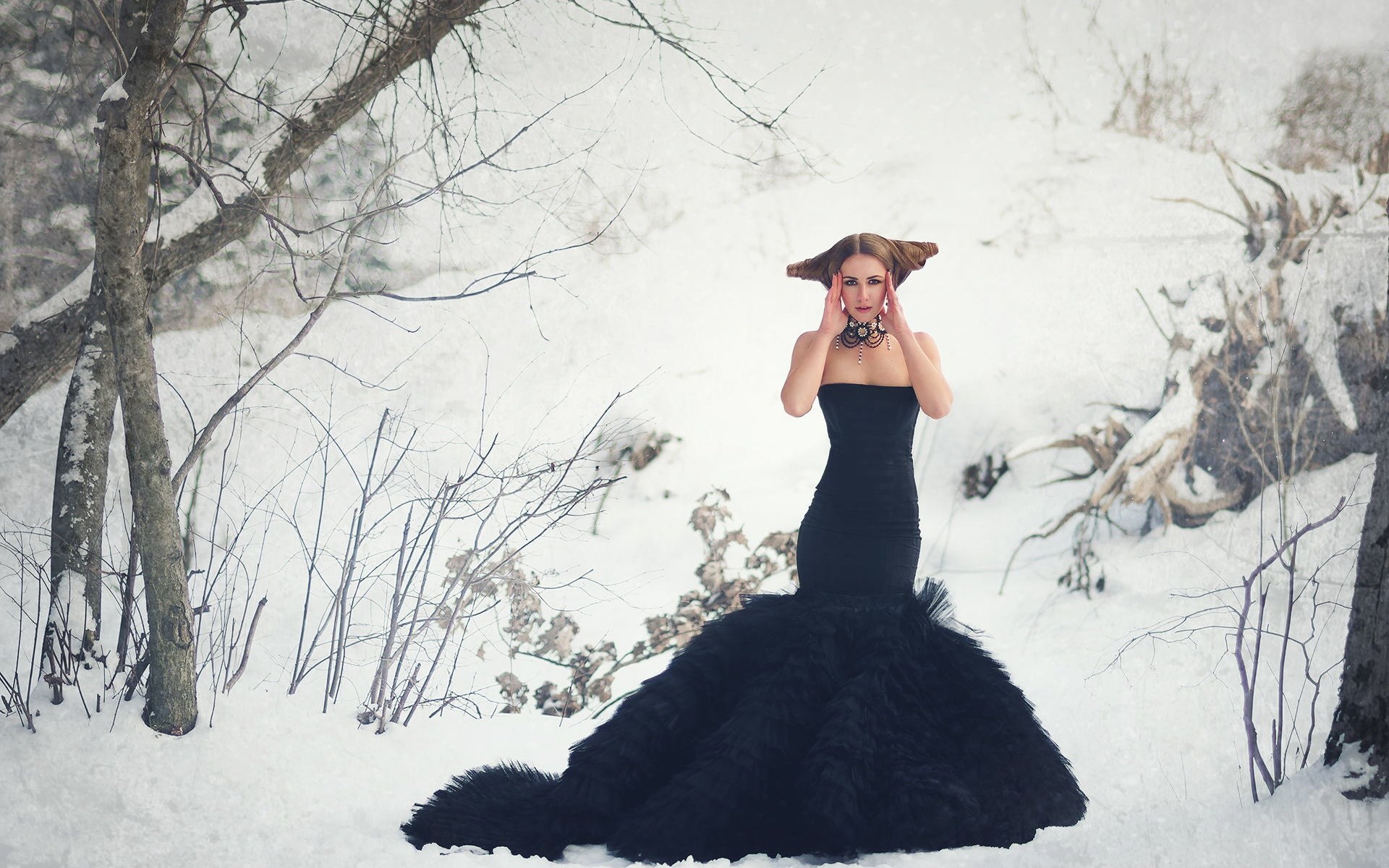 Woman in black dress in snowy forest HD Wallpaper