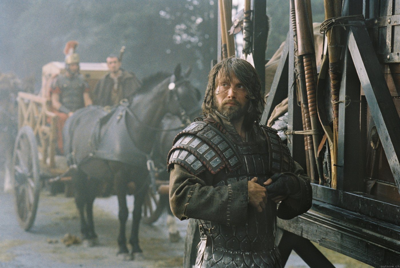 Mads Mikkelsen in armor with a cart and horses HD Wallpaper