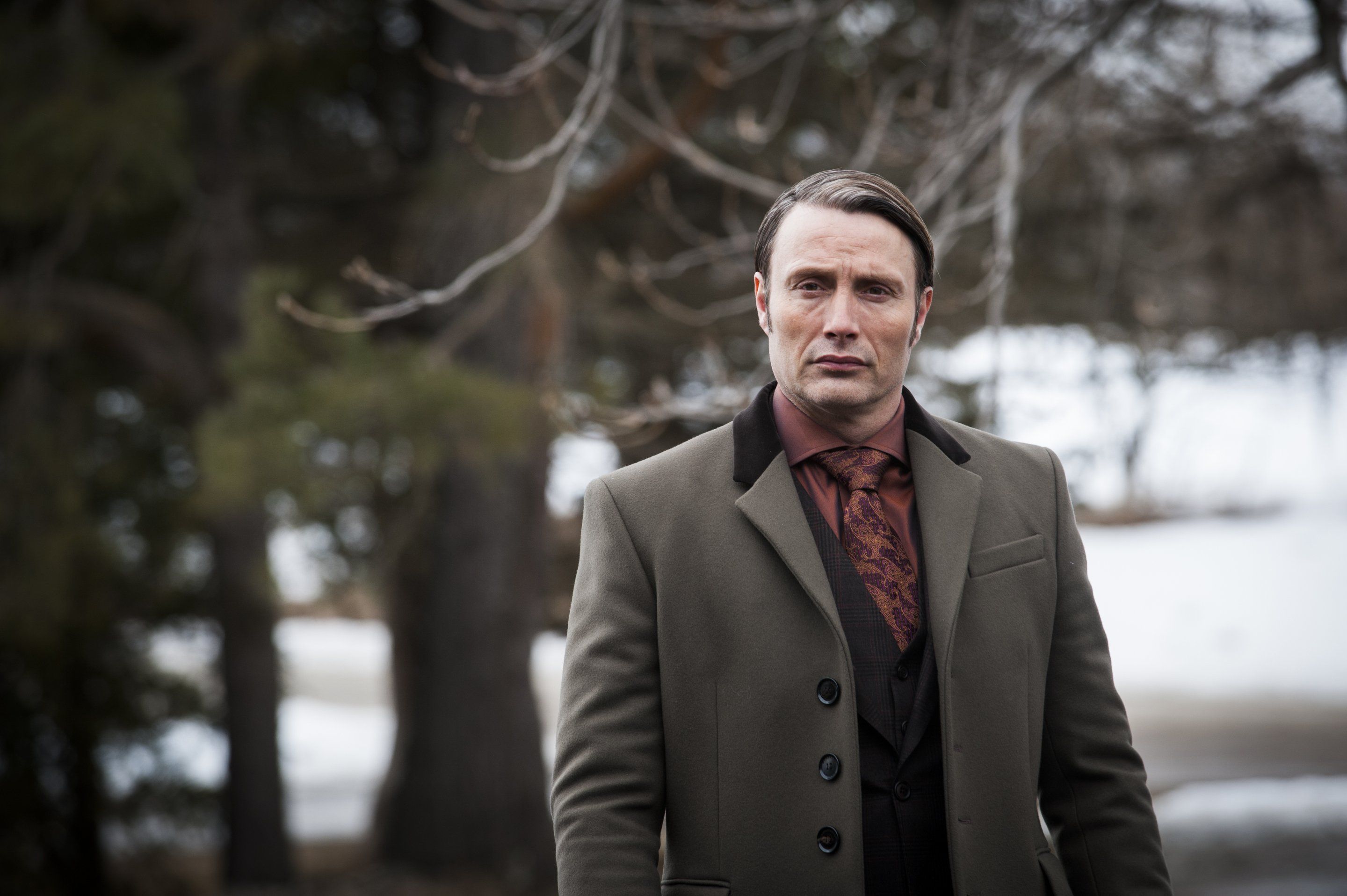 Mads Mikkelsen in a suit outdoors HD Wallpaper