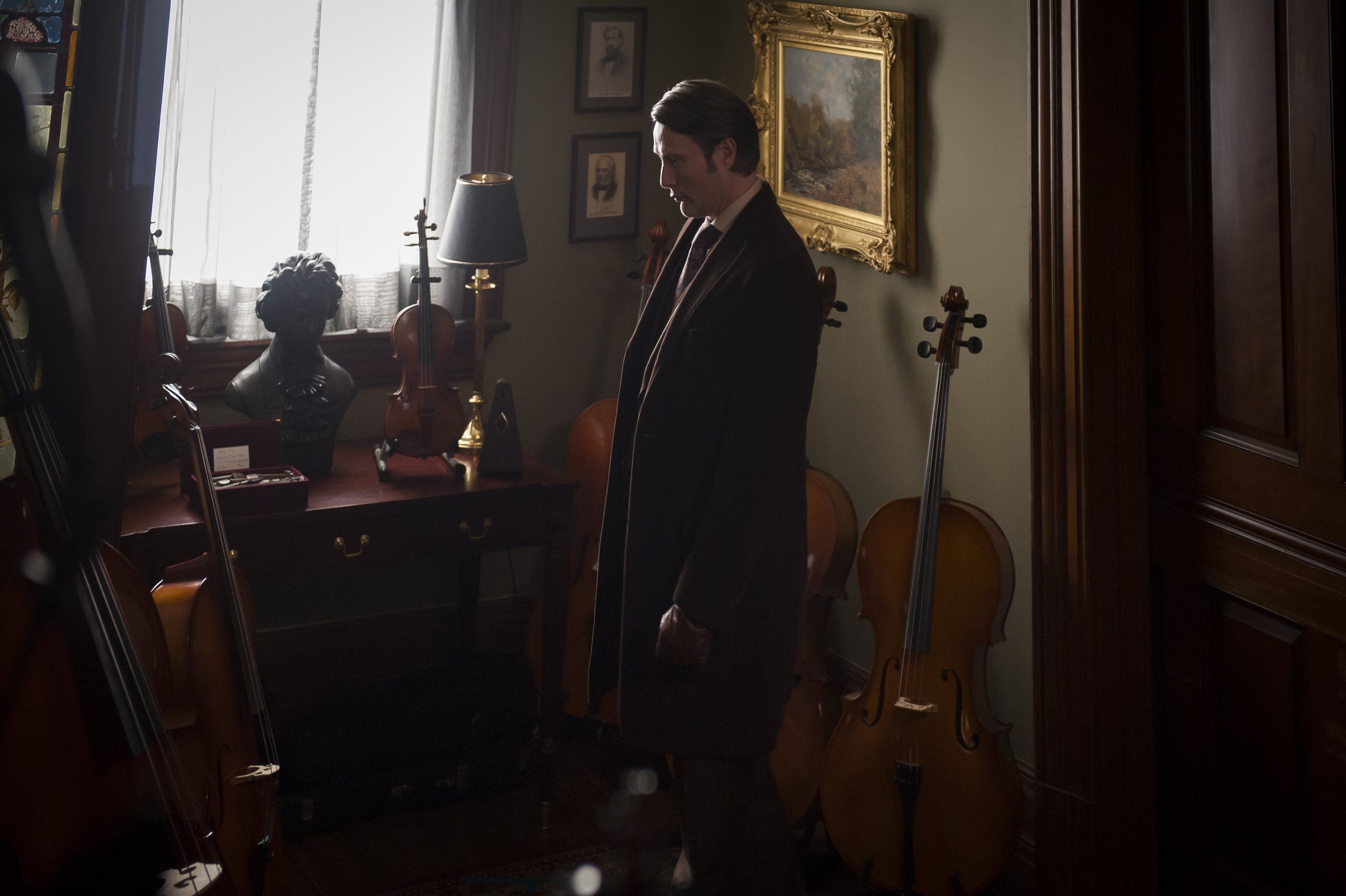 Mads Mikkelsen in a room with cellos HD Wallpaper