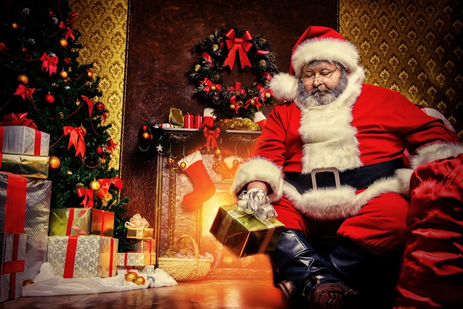 Santa Claus with gifts by a Christmas tree HD Wallpaper