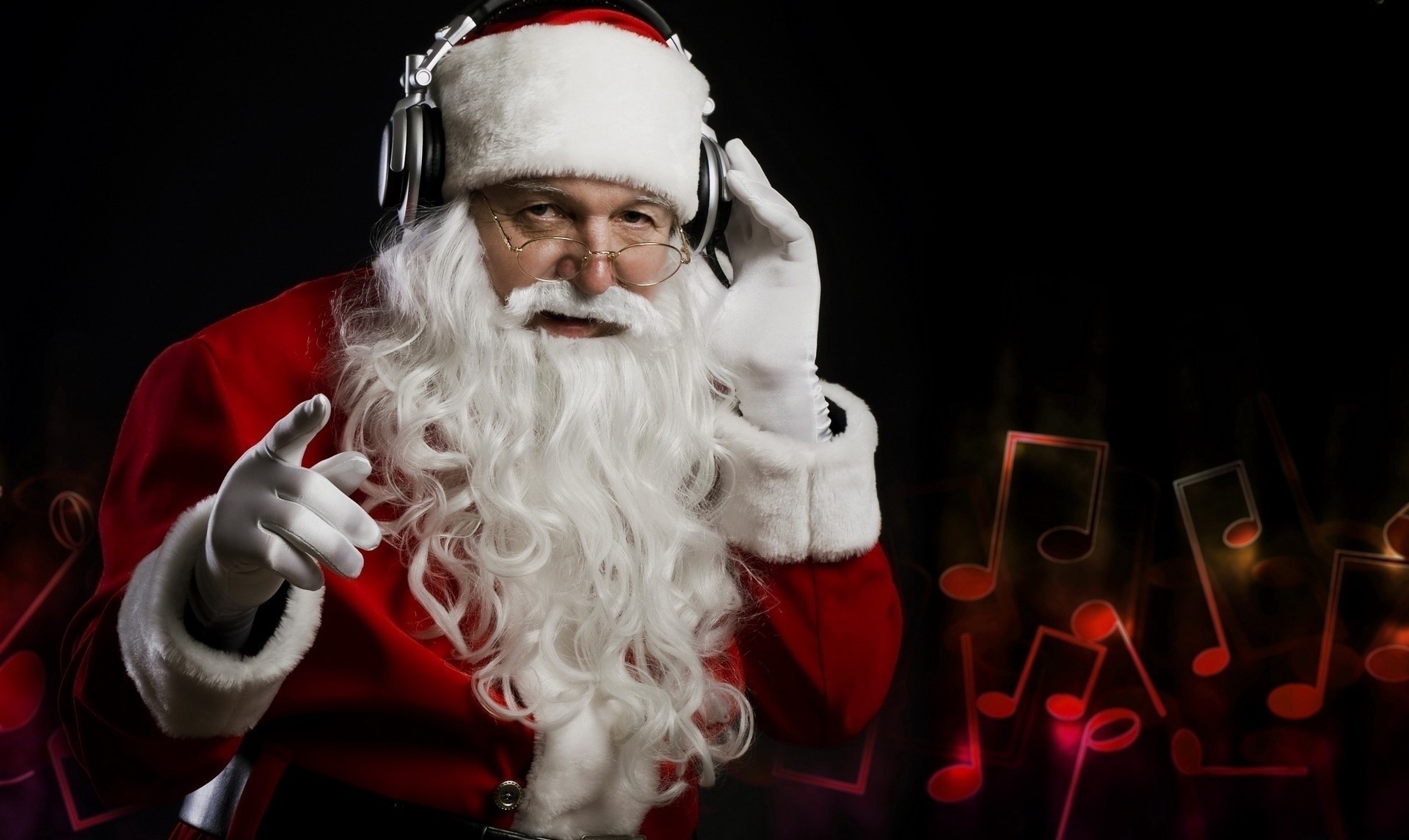 Santa Claus wearing headphones and pointing HD Wallpaper
