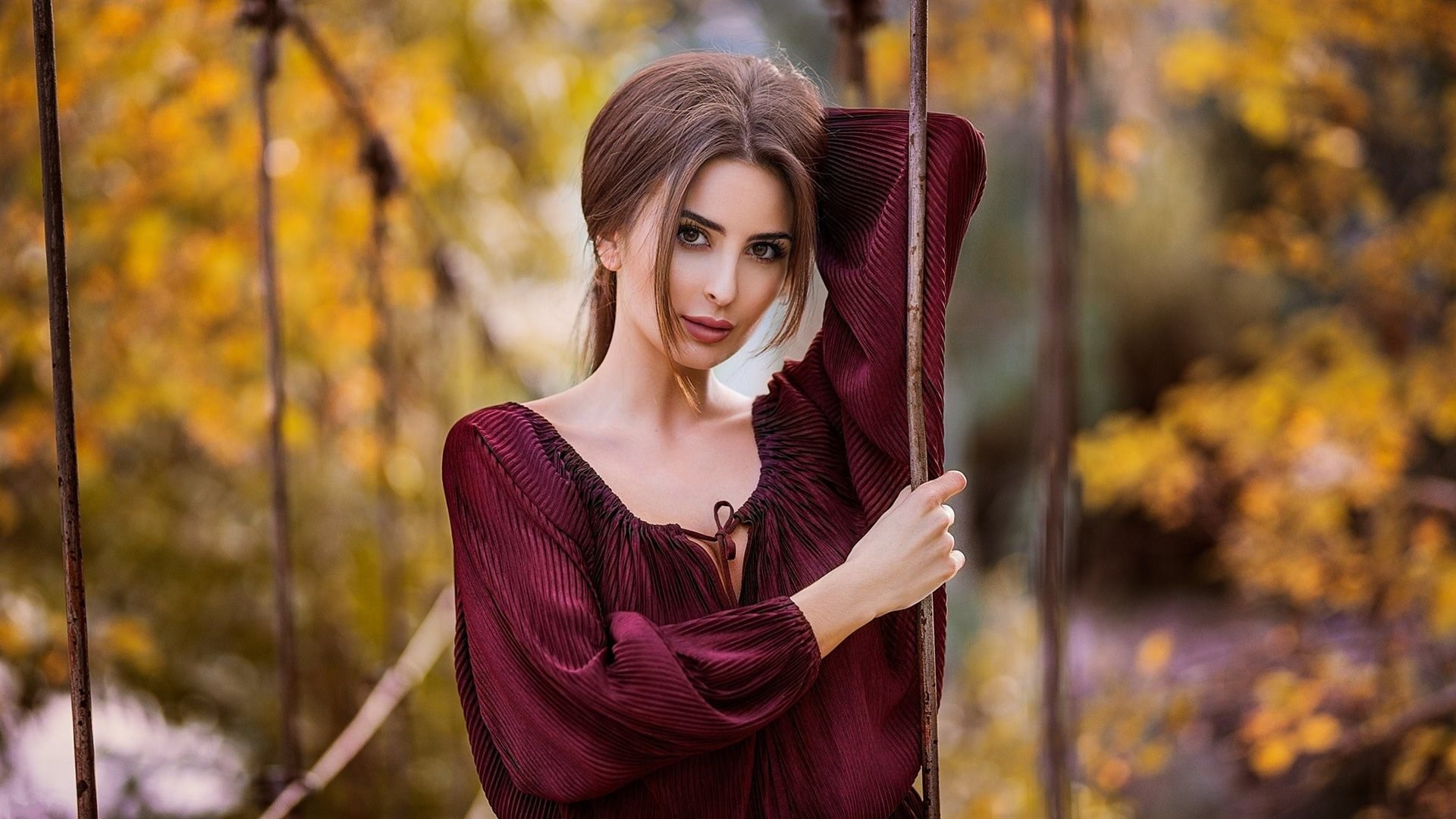 Woman in a maroon dress posing outdoors HD Wallpaper